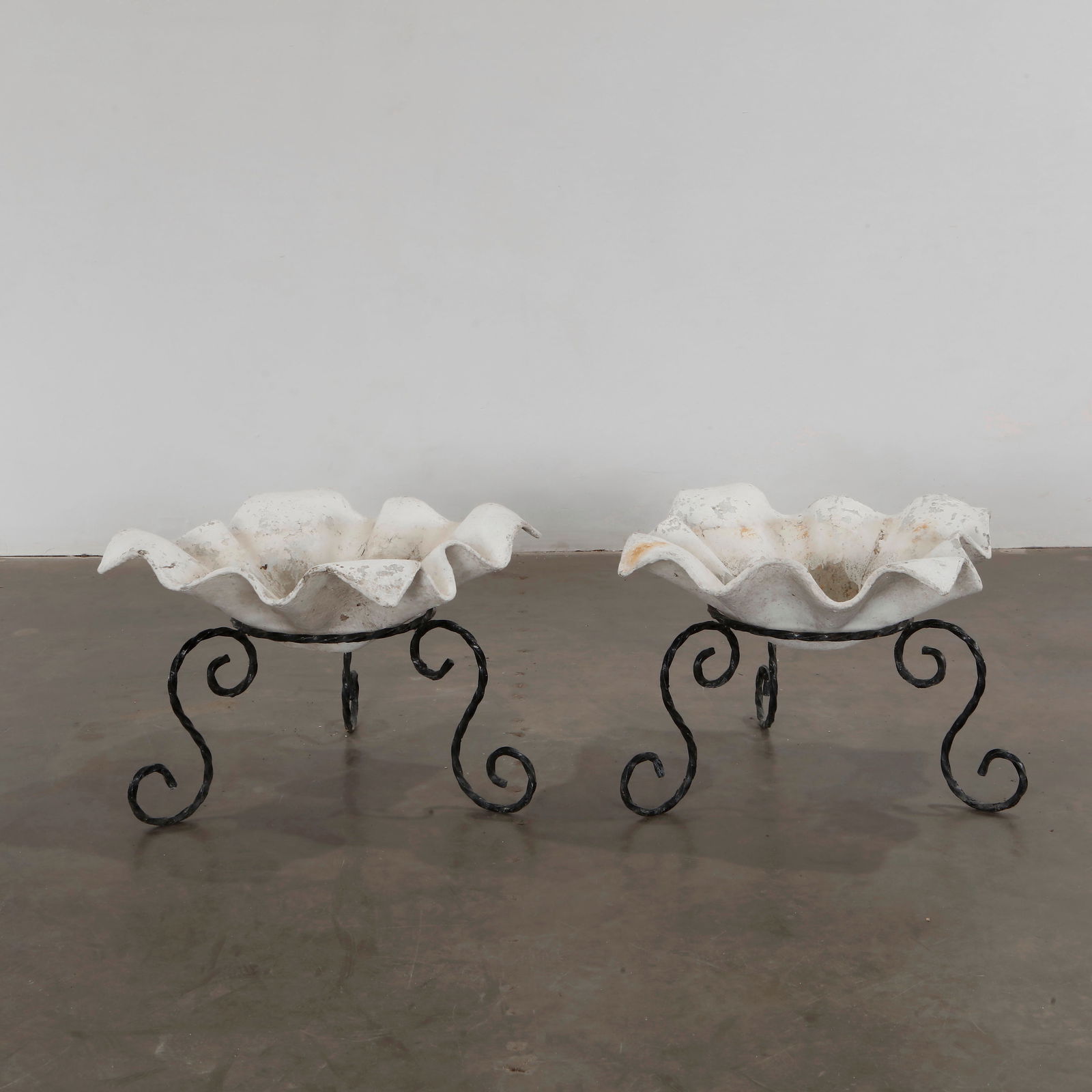 Willy Guhl, Pair of Small Elephant Ear Planters on Stands, 1960s: Pair of Small Elephant Ear planters, also known as handkerchief planters, by Willy Guhl for Eternit, Switzerland circa 1960s. Factory-drilled drainage holes. Wonderful patina. Height: 17 in. Length: 2