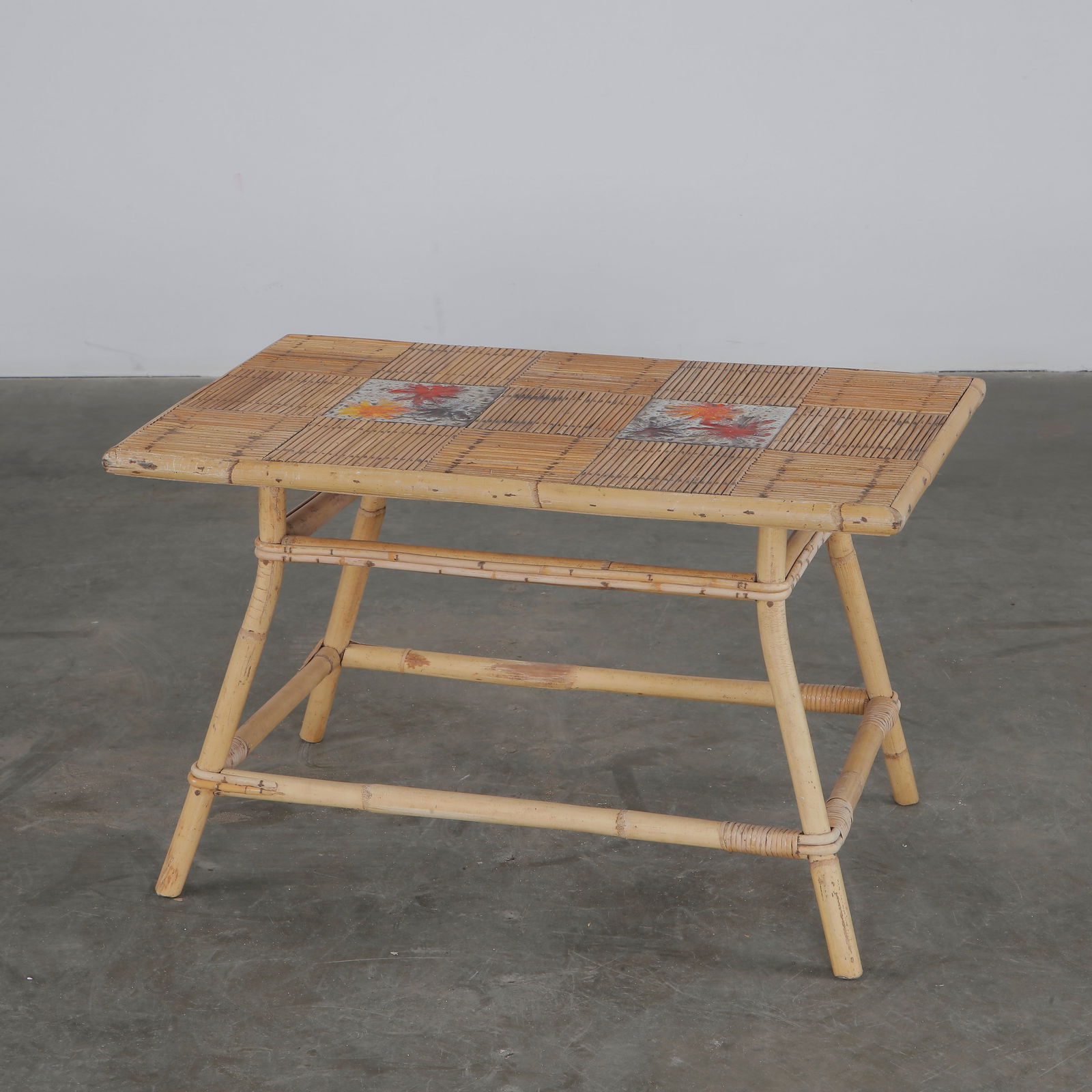 Audoux Minet, Coffee Table for Roger Capron, 1960s: Charming rattan and tile coffee table by Audoux-Minet for Roger Capron, featuring hand-painted floral ceramic inserts. France, 1950s.