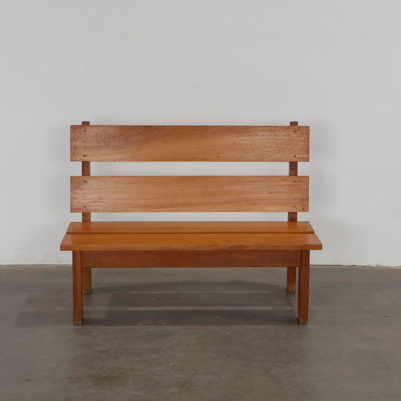 Brutalist Wood Bench in the Style of Pierre Chapo, 1960s: Angular wood bench with bold lines and slatted backrest, showcasing Brutalist form. Height: 31.5 in. Width: 43.2 in. Depth: 24.5 in. Seat Depth: 20.5 in. Seat Height: 14 in.