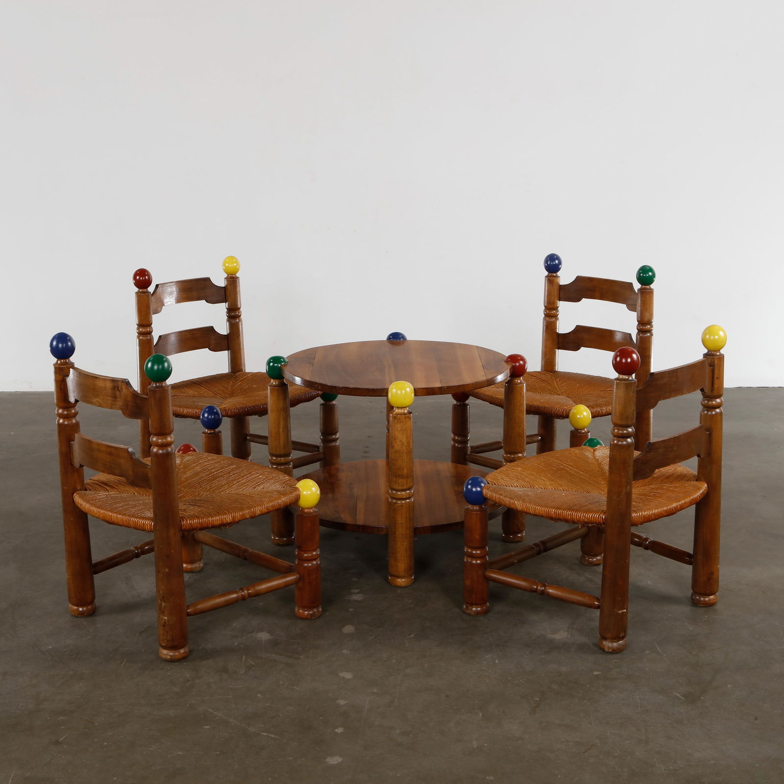 Charles Dudouyt, Coffee Table with Four Chairs, 1960s: Solid oak set with colorful wooden ball accents. Iconic playful French design. Height: 30.5 in. Width: 23 in. Depth: 19 in. Seat Depth: 21 in. Seat Height: 14.5 in. Coffee table: Height: 35 in. Width:
