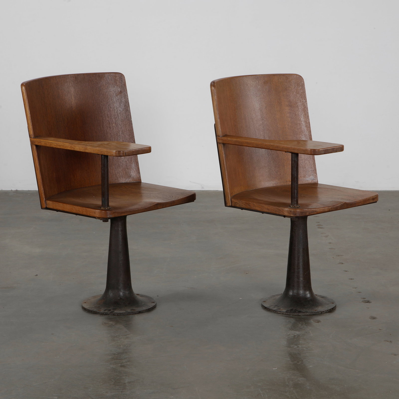 Emerson Bailey, Pair of 1930 University Chairs: Pair of French university chairs by Emerson Bailey, with one armrest for taking notes. Great patina and shape. 1930s, France. Height: 36 in. Width: 20 in. Depth: 21 in.
