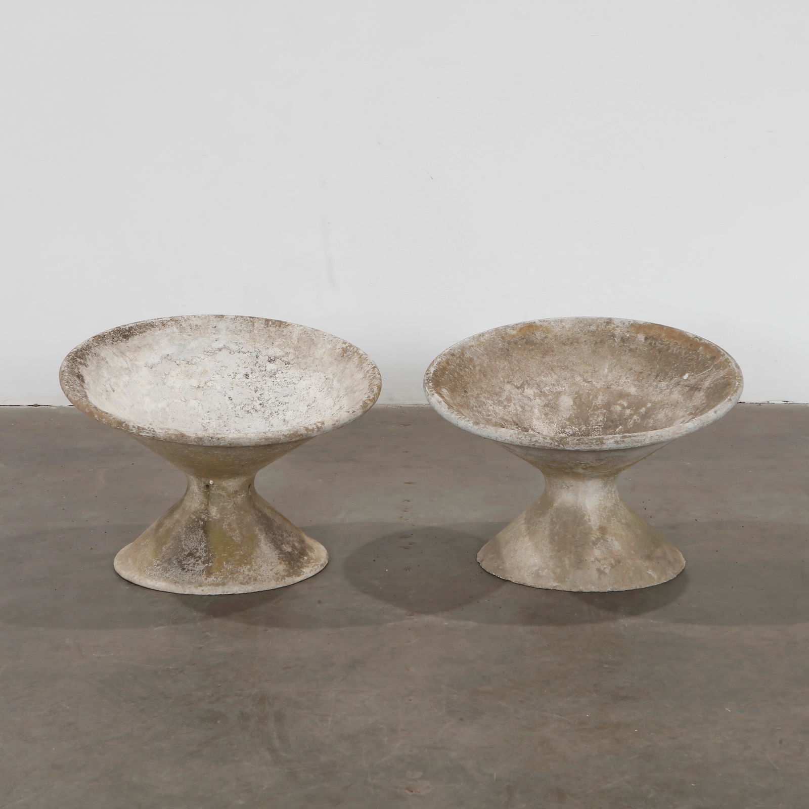 Willy Guhl, Pair of Off-Kilter Planters, 1960s: Pair of rare asymmetrical planters by Willy Guhl, featuring a bold modernist design. Height: 18 in. Diameter 25 in.