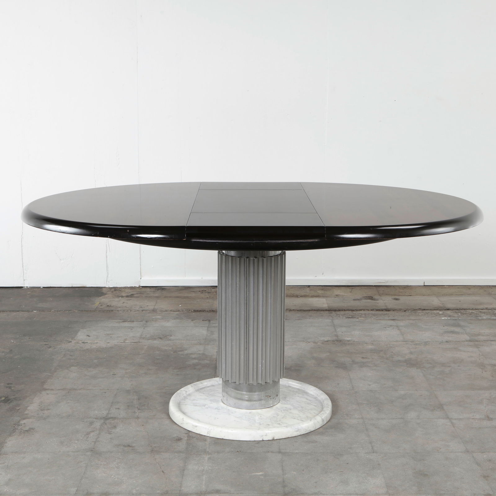 Italian Round Dining Table in the style of Christian Krass, 1960s: Round dining table with a richly polished wooden top supported by a central column on a marble base. The striking combination of materials and proportions gives the piece a bold architectural presence