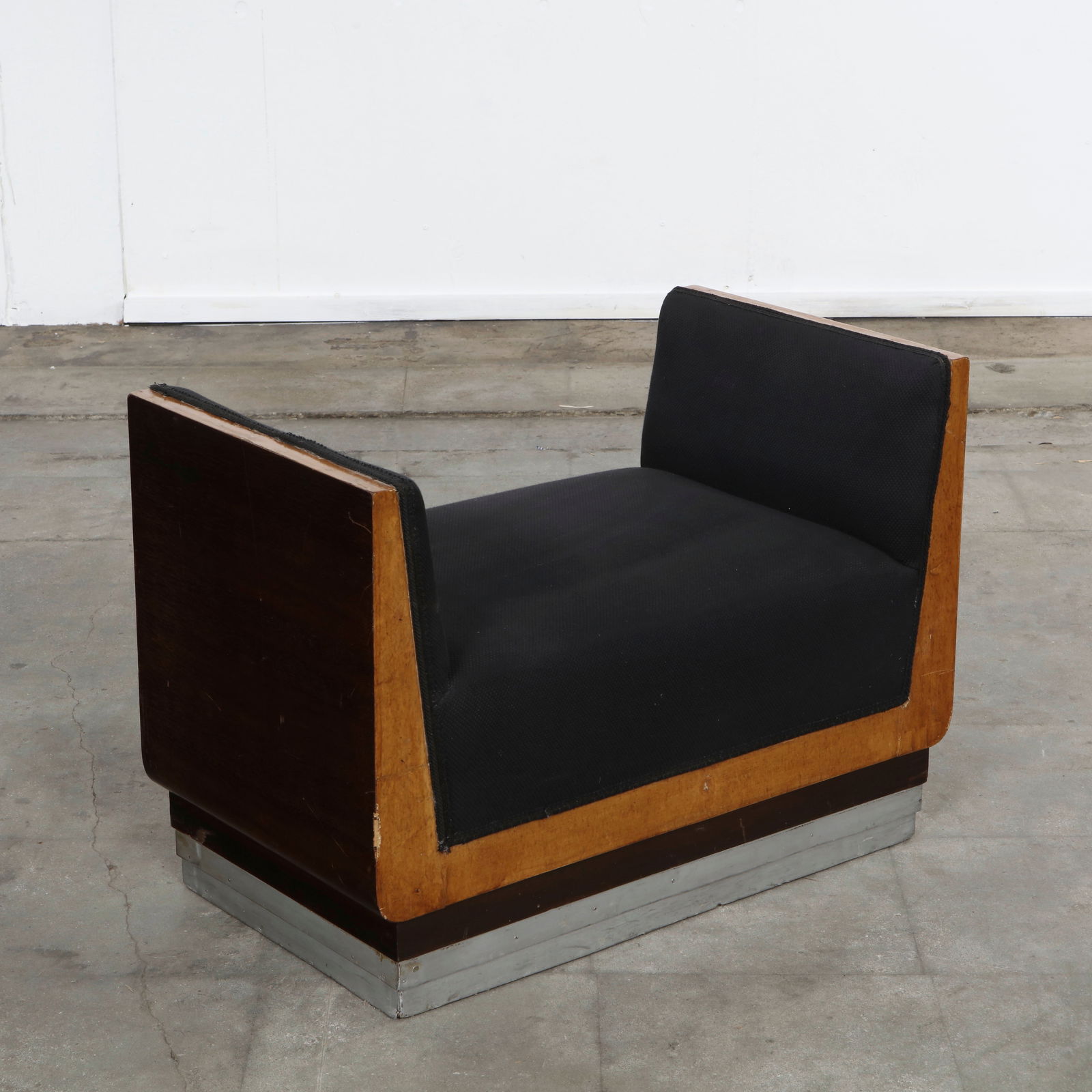Modernist Single Seater Bench, 1970s: Compact lounge seat with clean lines, wood panel sides, and a cushioned seat. A minimalist design ideal for modern or eclectic interiors. Height: 20 in. Length: 27.5 in. Width: 16 in. Seat Height: 13