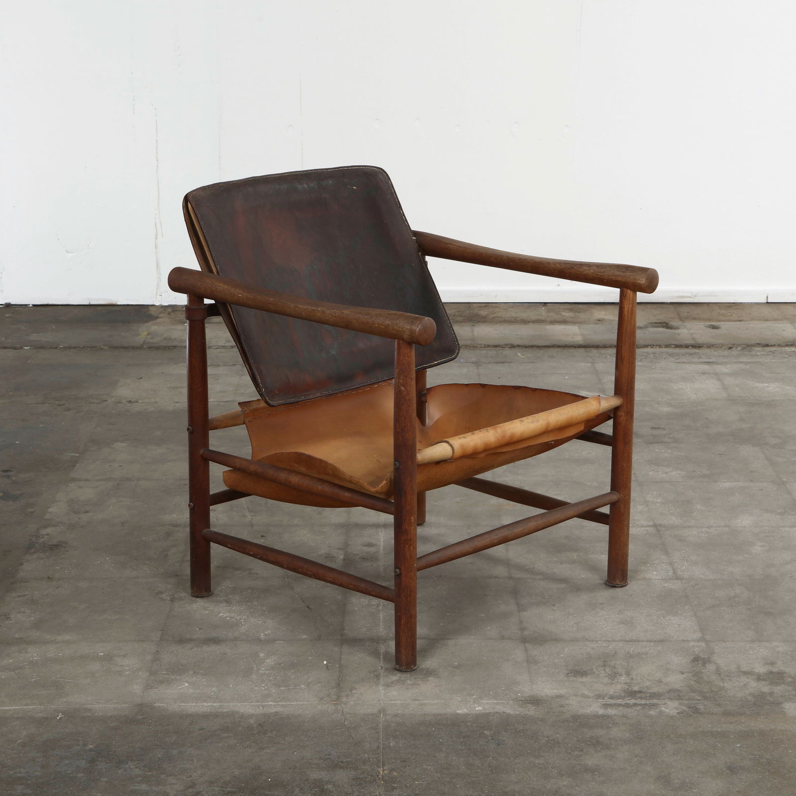 Safari Armchair in the style of Karen & Ebbe Clemmensen, 1960s: Danish safari chair with a teak frame and original leather sling seat and back, attributed to the style of Clemmensen, 1960s. Height: 29 in. Width: 24 in. Depth: 23.5 in. Seat Depth: 20 in. Seat Heigh