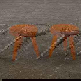 Pair of Small Wooden Stools Attribuded to Charlotte Perriand, 1960s: Crafted in solid wood with rounded seats and tapered legs, these stools reflect Perriand's refined approach to rustic modernism. Their simple geometry and warm patina highlight both function and artis