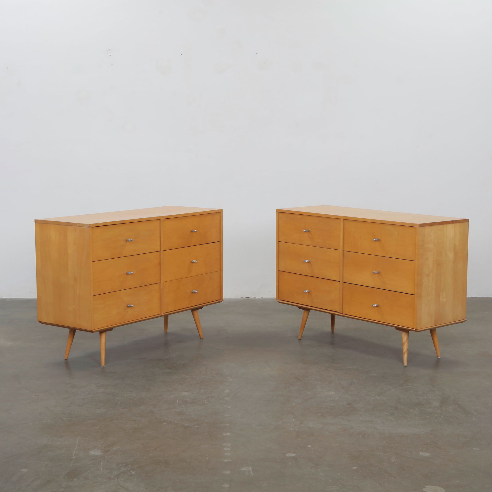 Paul McCobb for Winchendon Furniture, Pair of 6-Drawer Dressers, 1950s: Maple dressers with splayed legs and minimalist detailing, icons of McCobb Planner Group series. Height: 34 in. Width: 48 in. Depth: 18.25 in. .