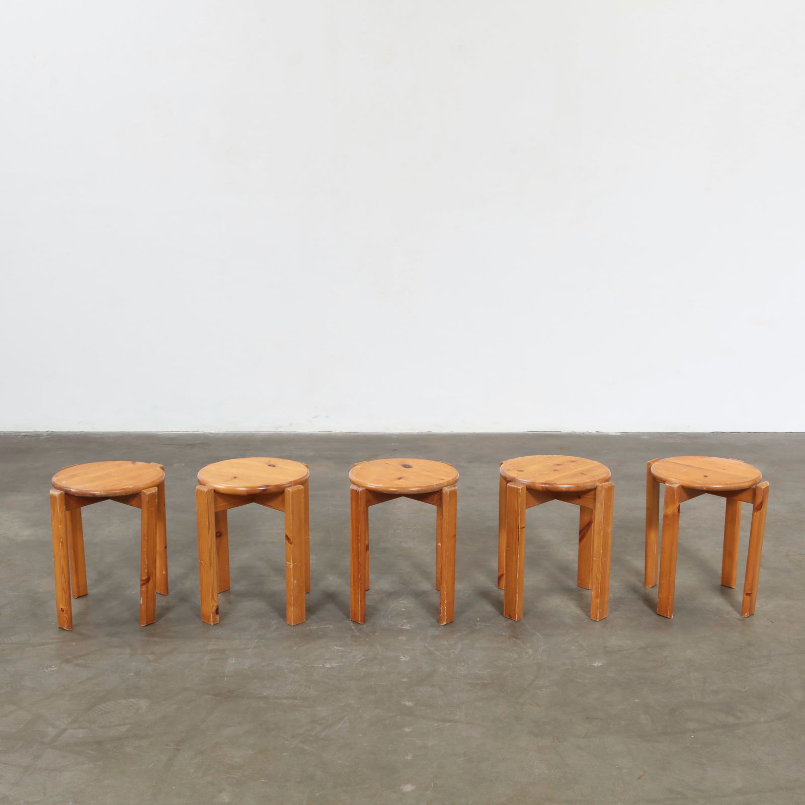 Bruno Rey, Set of Five Wooden Stools, Switzerland, 1970s: Composed of molded beech with Rey patented screwless joinery, this set highlights the designer technical ingenuity. The stools fluid curves and stackable form epitomize functional modernism. Height: 1