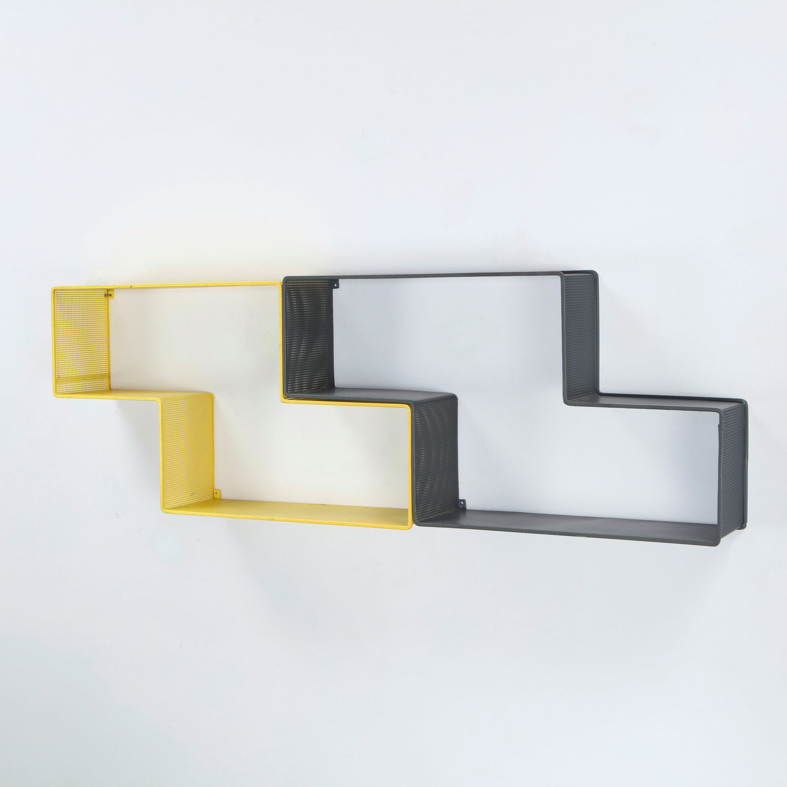 Mathieu Mategot, Pair of Wall Shelves in Perforated Metal, France, 1950s: Executed in Mategot signature Rigitulle technique, these perforated metal shelves showcase a rhythmic interplay of light and geometry. Their sculptural silhouette captures the designer modernist artis