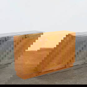 Charlotte Perriand, Pine Sideboard, 1960s: Solid pine sideboard featuring paneled doors and rounded wooden pulls. Evoking Perriand mountain-chalet aesthetic, this piece balances rustic warmth with architectural simplicity. Height: 33 in. Width