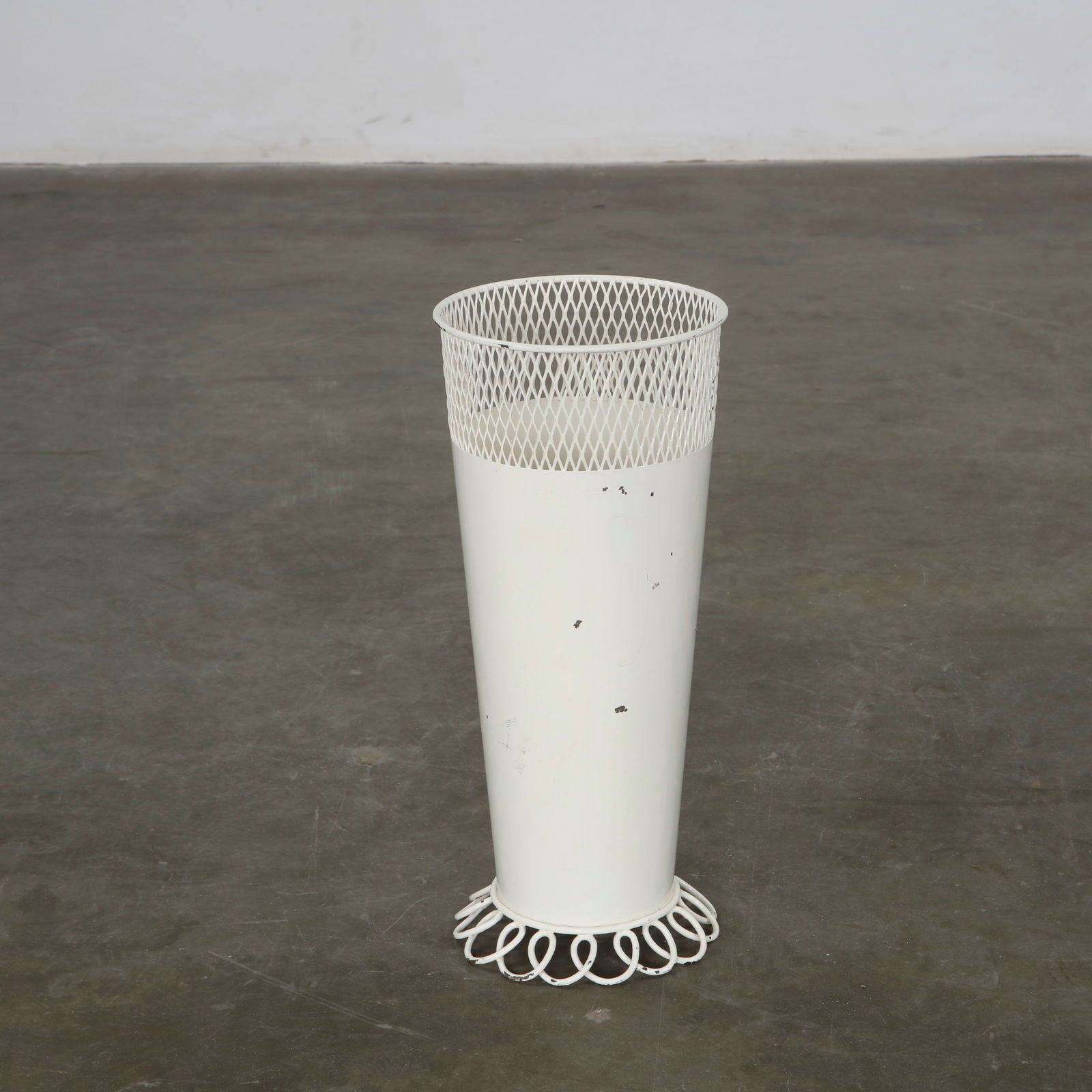 Mathieu Mategot, Umbrella Holder, France, 1950s: Executed in perforated sheet metal with a white lacquer finish, this elegant vessel reflects Mategot mastery of metalwork and poetic use of industrial materials. A sculptural accent uniting utility an