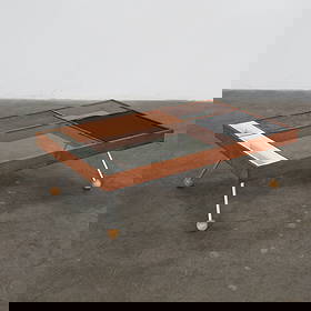 Milo Baughman for Glenn of California Cocktail Table, Model Number 500, 1950s: Walnut coffee table with a segmented top of wood, glass, and metal, including a storage bin and perforated Masonite hinged compartment. Height: 14 in. Width: 30 in. Depth: 48 in.