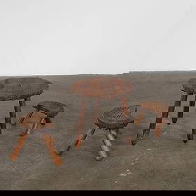 Set of Brutalist Coffee Table with Wooden Stools, 1960s: Primitive and sculptural set in solid wood. A striking trio with expressive grain and organic forms. Small Stool: Height: 7.9 in. Width: 12 in. Depth: 6 in. Taller Stool: Height: 11.5 in. Width: 14.5