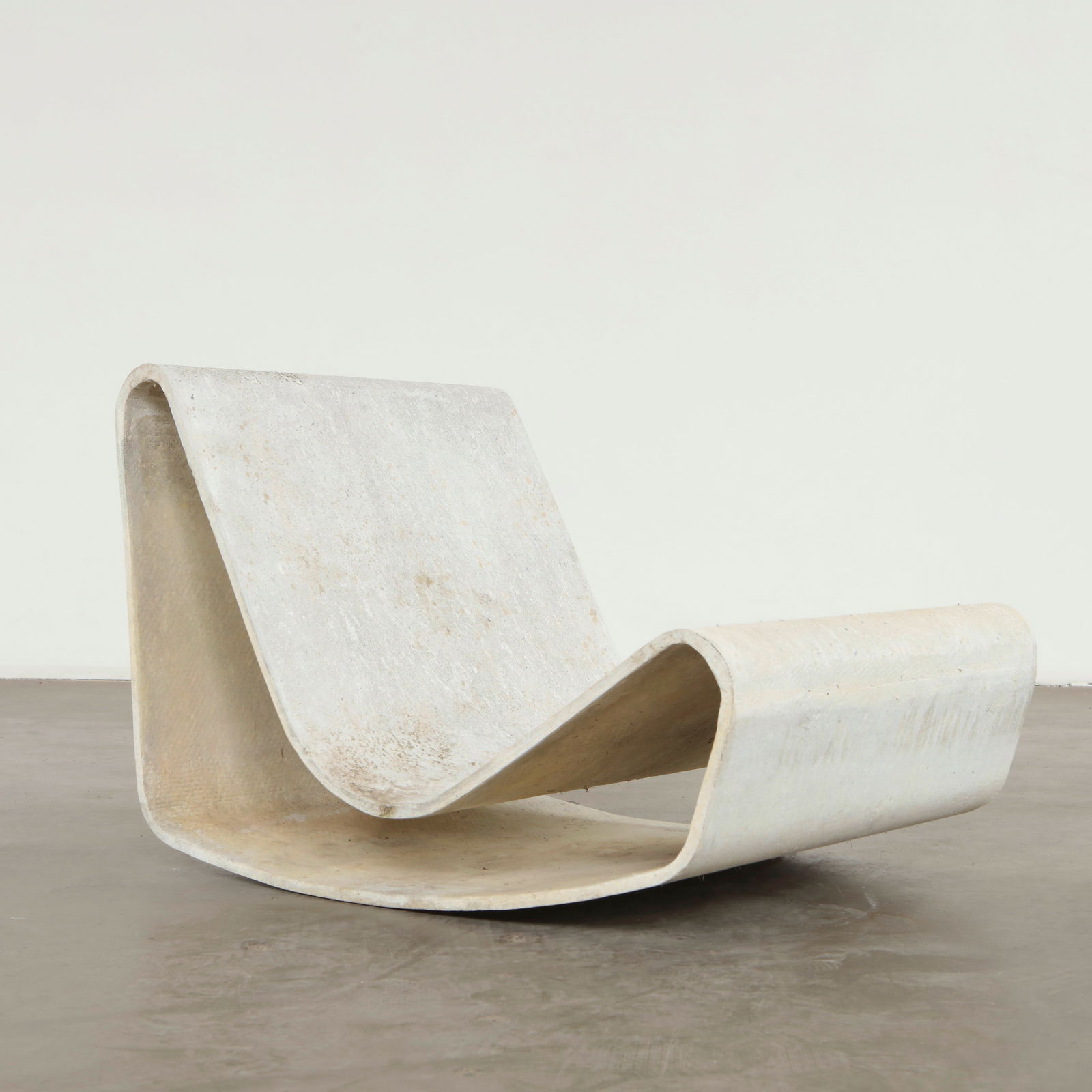 Willy Guhl, Loop Chair, 1960s: Cast in molded cement, this chair reflects Guhl pioneering approach to durable sculptural outdoor furniture. The continuous bent form offers a serene minimal profile shaped by structural clarity and m