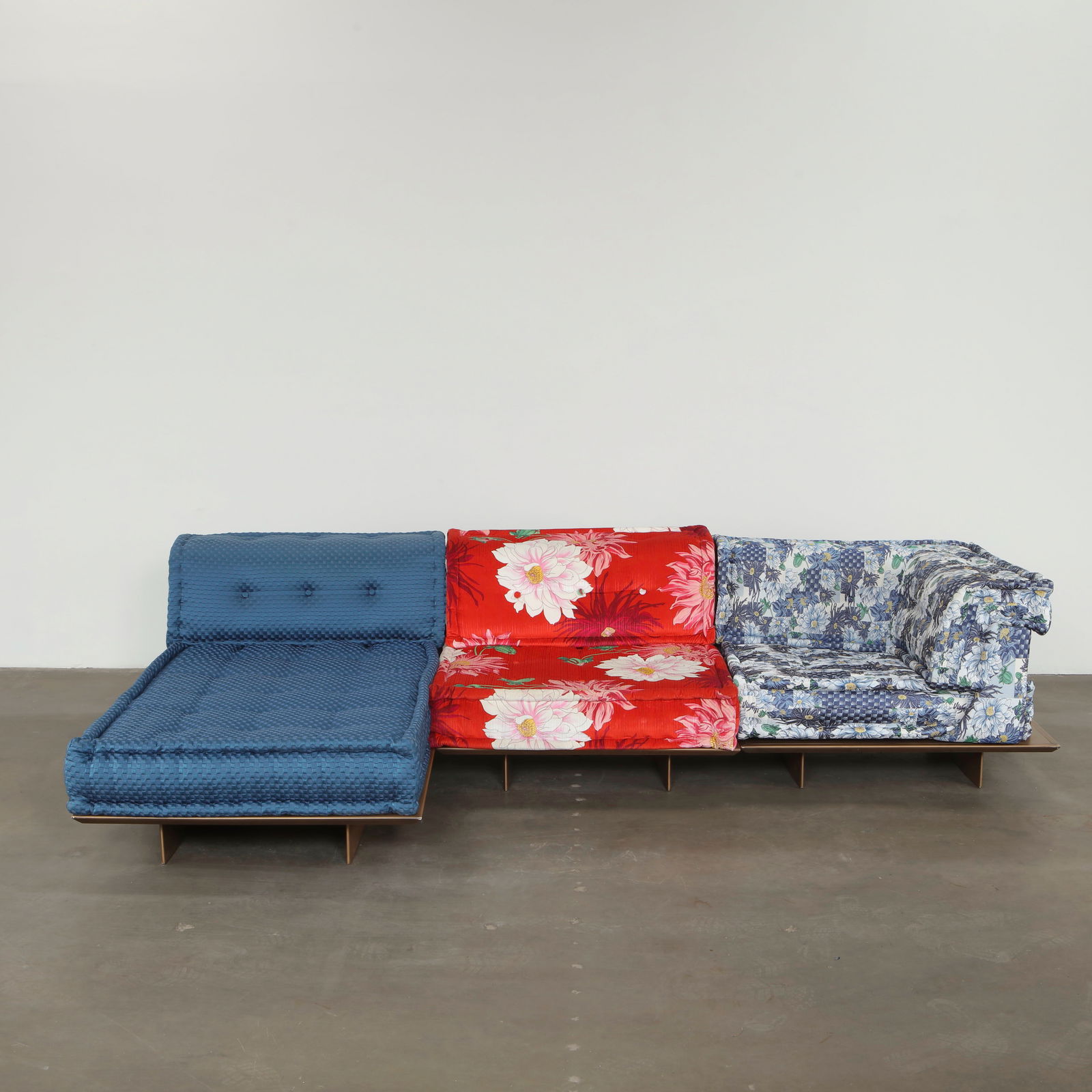 Hans Hopfer for Roche Bobois, 6-Piece Mah Jong Sofa with Platform and Kenzo Fabric, 2000s: This expansive 6-piece composition includes an integrated wood platform base, a rare variation on the iconic Mah Jong sofa with a Kenzo fabric, uniting sculptural form and maximalist textile curation.