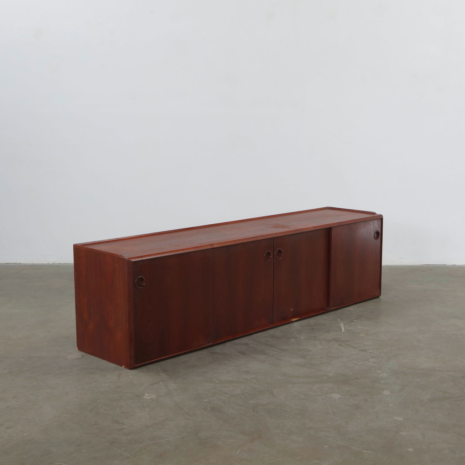 Sideboard Attributed to Arne Vodder, Denmark, 1950s: Rosewood sideboard with sliding doors and sculpted drawer fronts, reflecting Vodder signature Scandinavian sensibility. The piece combines refined joinery with functional elegance, characteristic of m