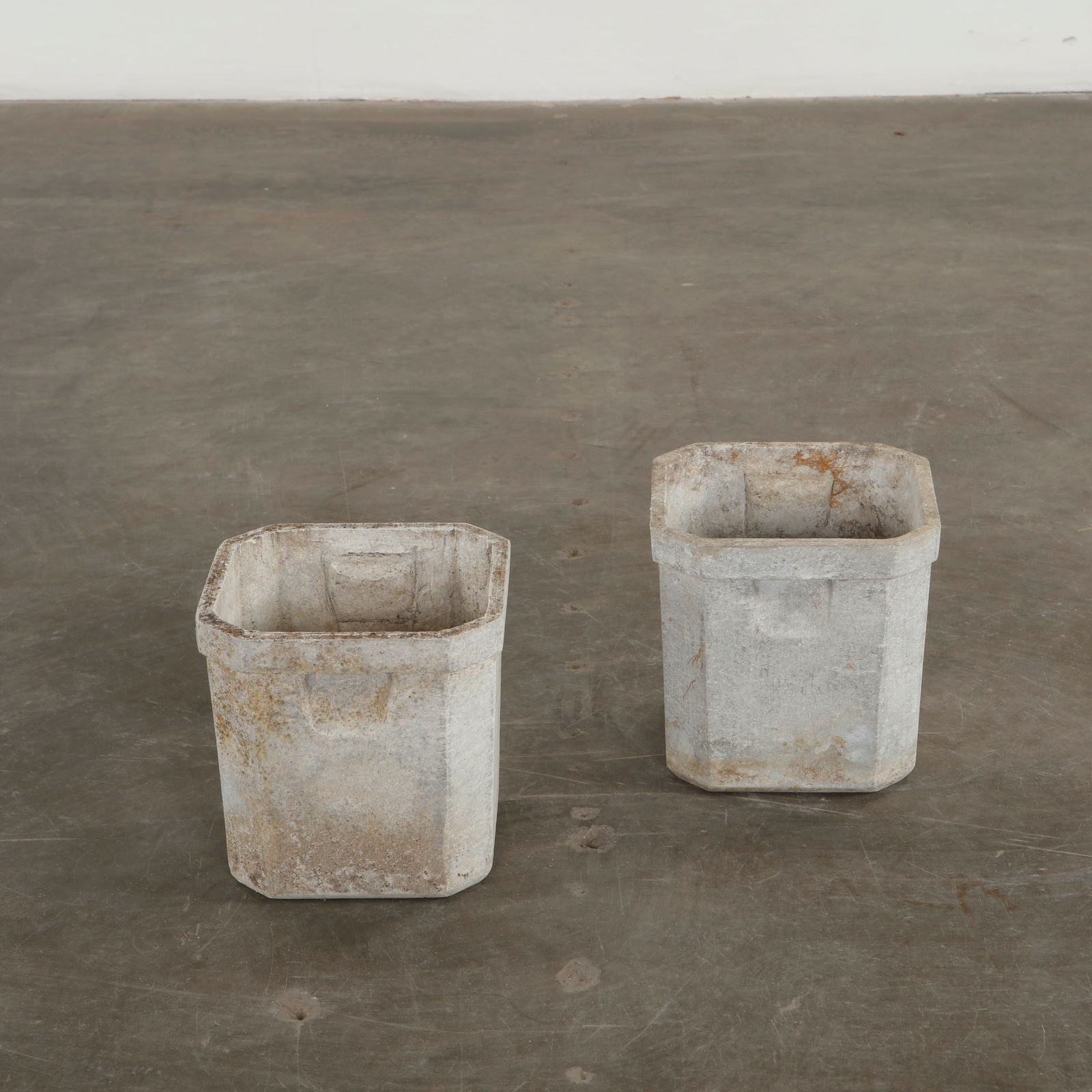 Willy Guhl, Pair of Small Square Planters, 1960s: Crafted in cement, these geometric vessels show the restrained clarity that defines Guhl outdoor design. Their weathered patina reveals years of natural aging, giving each piece a quiet sculptural pre