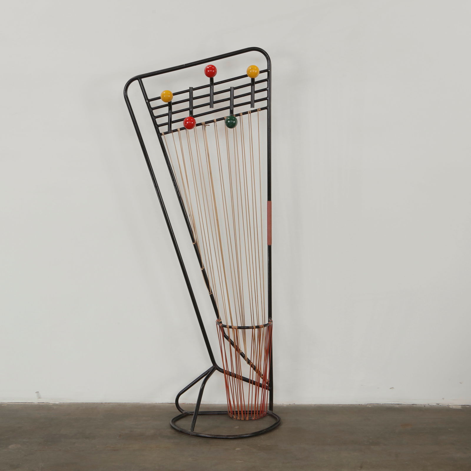 Roger Feraud, Atomic Hall Stand, 1960s: Executed in wrought metal with lacquered spherical accents, this hall stand displays the playful graphic energy of French atomic era design. The slender rods and vibrant colors create a dynamic sculpt