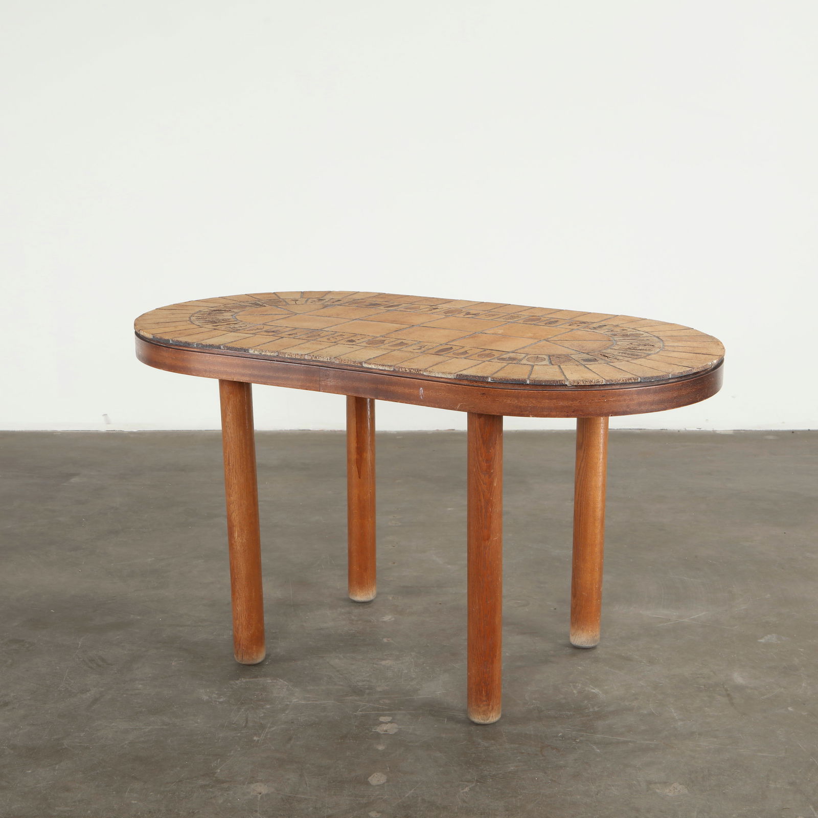 Roger Capron, Garrigue High Table, 1960s: The high table features Capron signature ceramic tiles, each hand-decorated with vegetal motifs and arranged in a refined oval composition. The warm tonality of the glazes enhances the sculptural rhyt