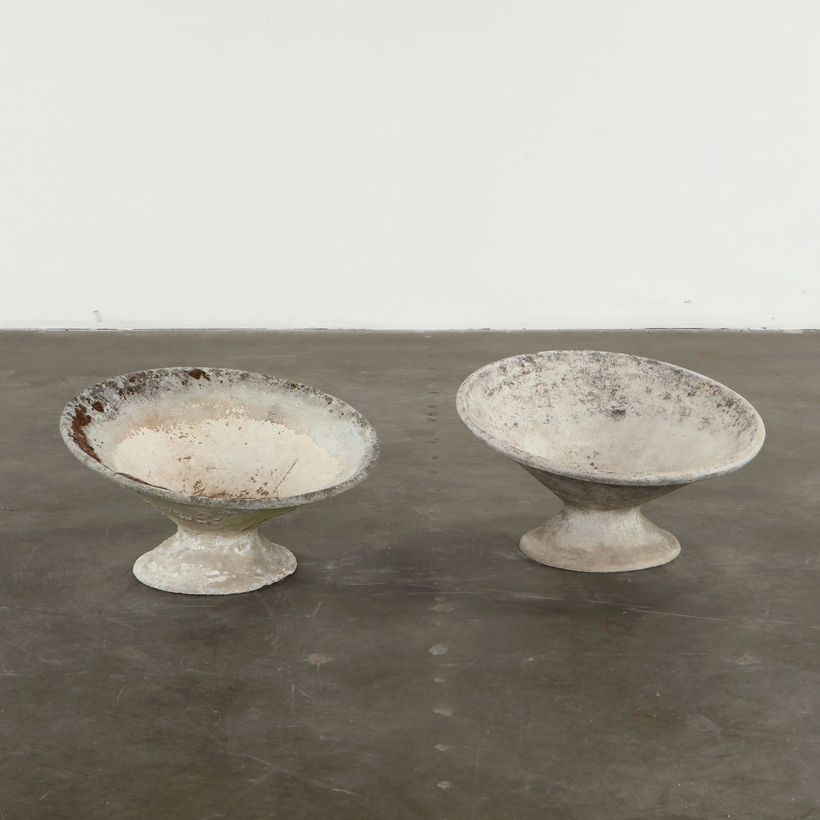 Willy Guhl, Pair of Off-Kilter Planters, 1960s: A pair of rare asymmetrical planters by Willy Guhl, featuring a bold modernist design. Height: 15 in. Diameter: 25 in.