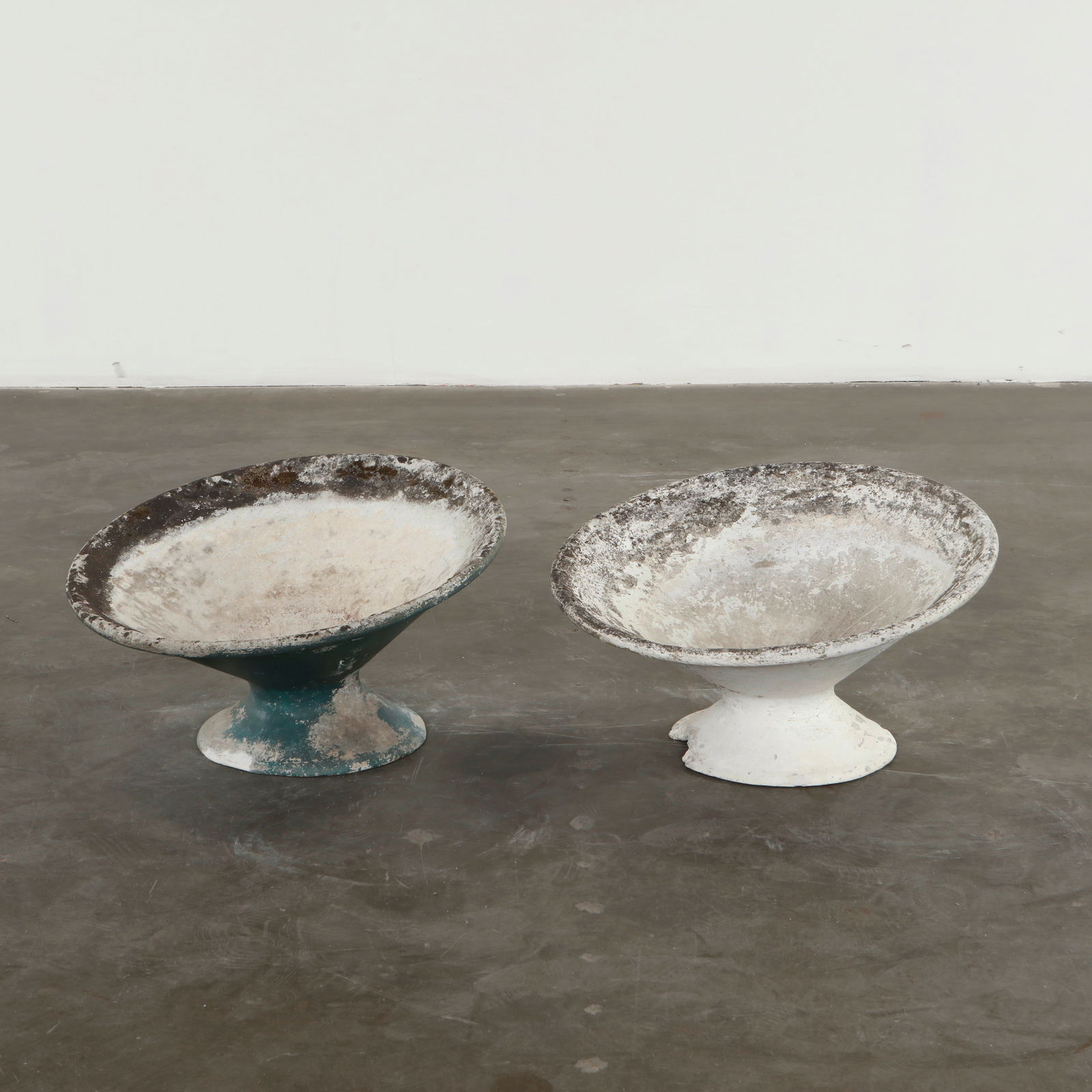 Willy Guhl, Pair of Off-Kilter Planters, 1960s: A pair of rare asymmetrical planters by Willy Guhl, featuring a bold modernist design. Height: 15 in. Diameter: 25 in.