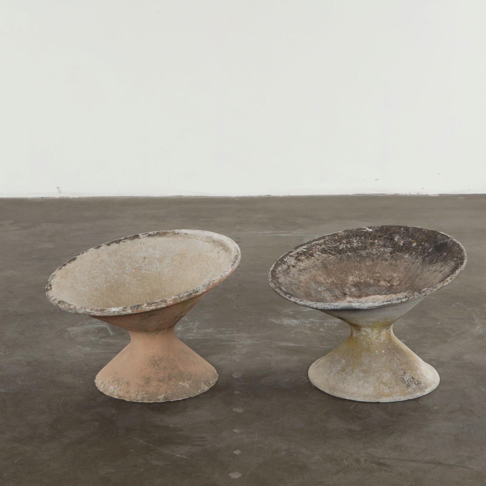 Willy Guhl, Pair of Off-Kilter Planters, 1960s: A pair of rare asymmetrical planters by Willy Guhl, featuring a bold modernist design. Height: 18 in. Diameter: 25 in.