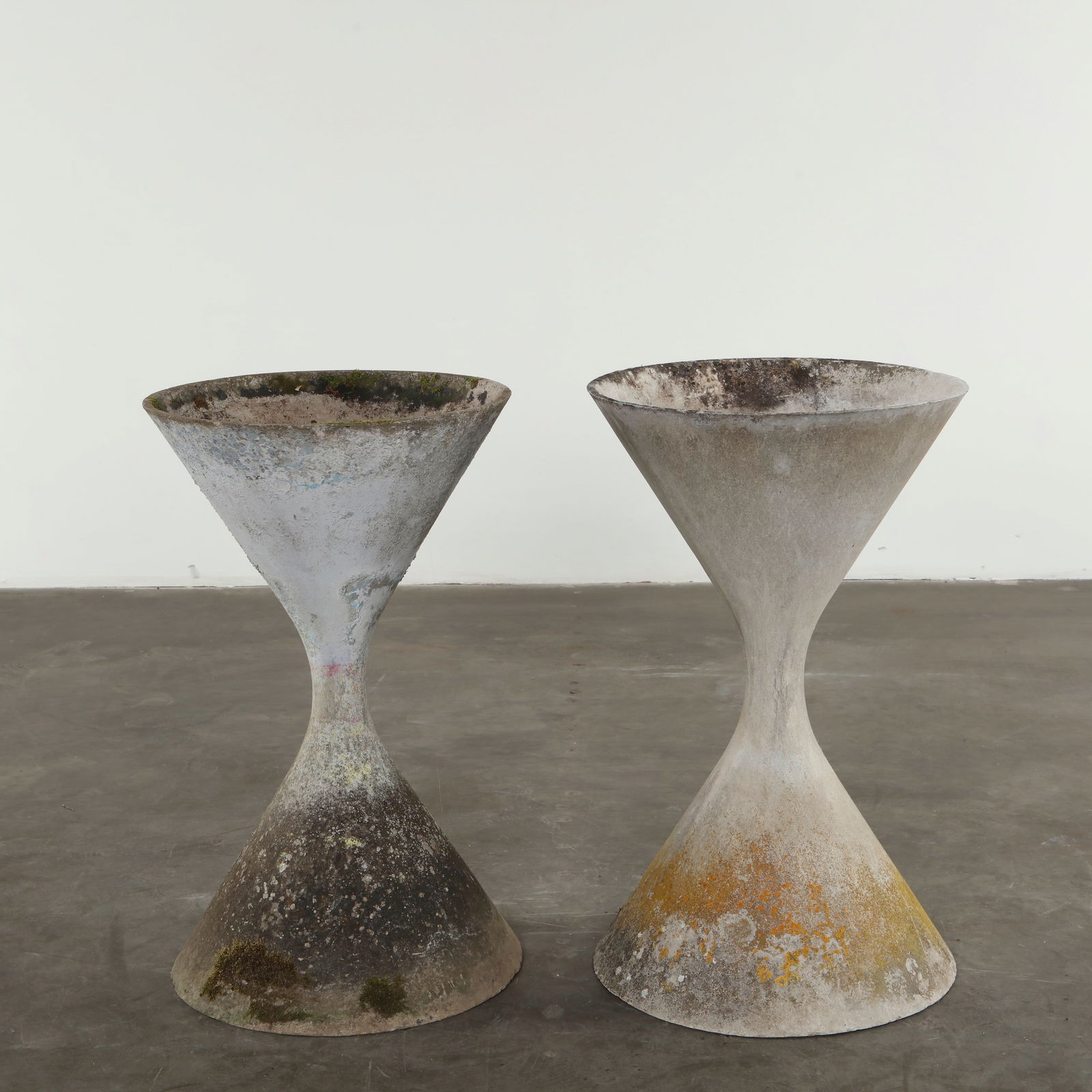 Willy Guhl, Pair of Large Diabolo Planters, 1960s: Cast in cement with the iconic hourglass form, these large-scale planters embody Guhls sculptural mastery and his pioneering outdoor material innovations. Their natural patina enhances the organic pur
