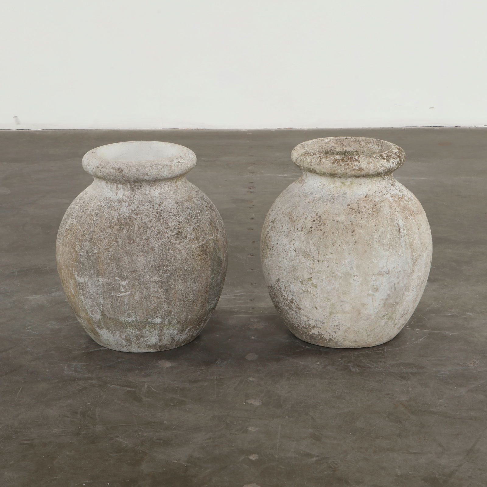 Willy Guhl, Pair of Jar Planters, 1960s: Hand-cast in cement with generous rounded bodies and tapered rims, these planters reflect Guhl pursuit of elemental outdoor forms. Their weathered surfaces reveal decades of natural patina, enhancing
