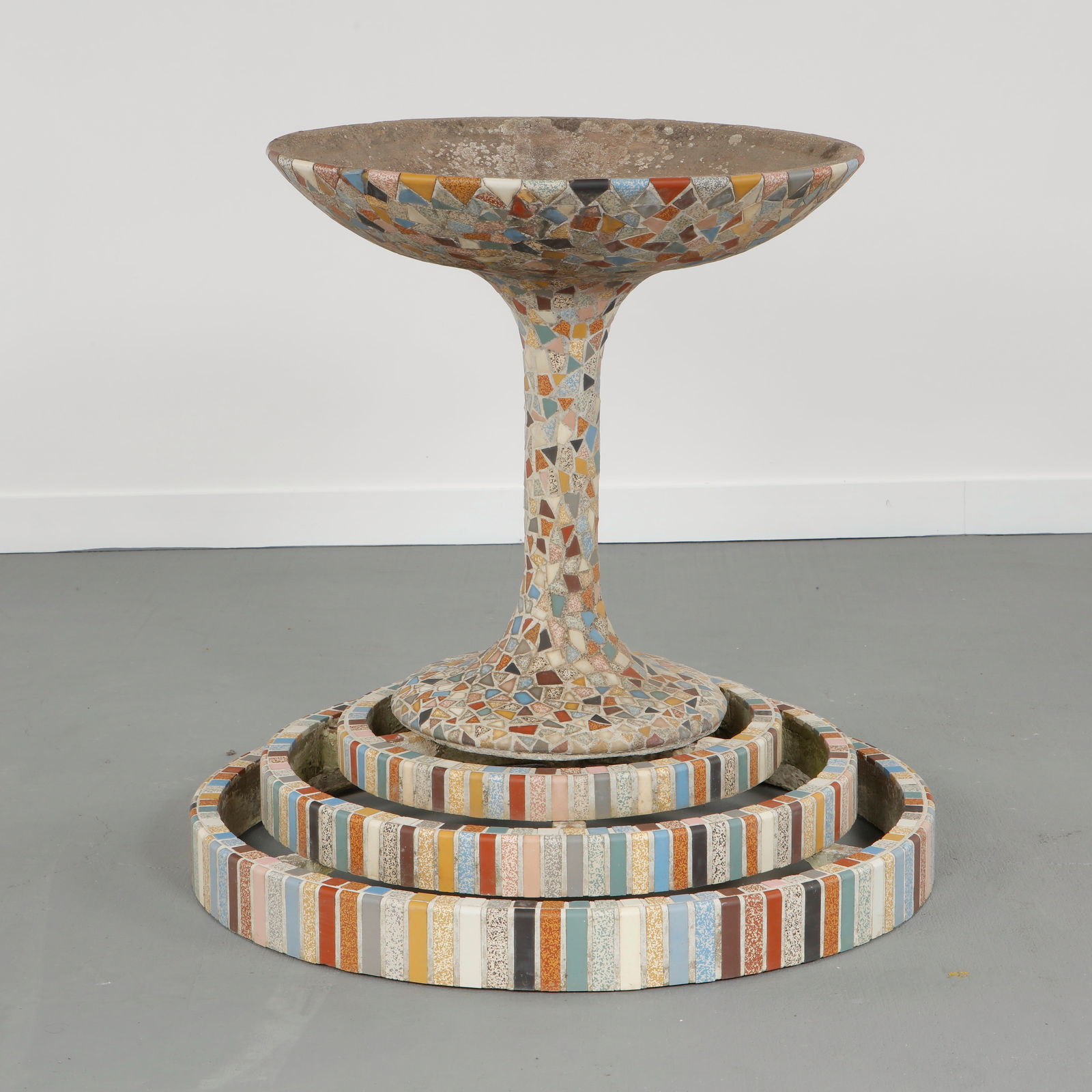 Mosaic Pedestal Fountain, Southern Europe, 1960s: Decorative fountain adorned with multicolored mosaic tiles and a stepped circular base. A sculptural outdoor feature merging artisanal craft and modern garden design. Height: 39 in. Diameter: 39 in. T