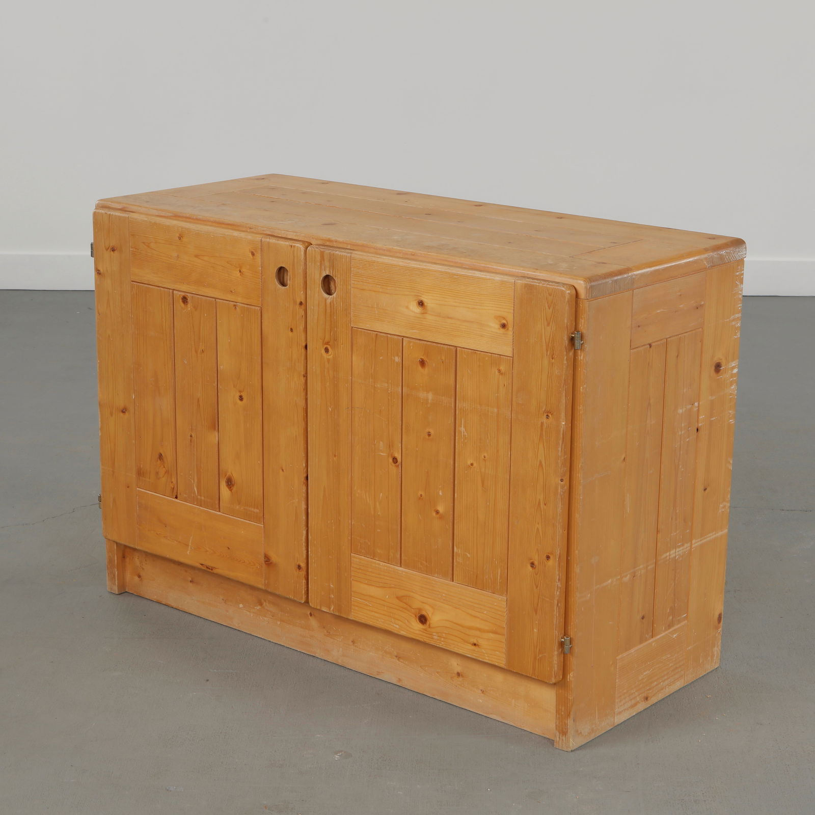 Charlotte Perriand for Les Arcs 1600, Pine Sideboard, 1960s: Pine wood sideboard with two doors, reflecting rustic modernism and utility. Height: 28 in. Length: 39.5 in. Width: 17.5 in.