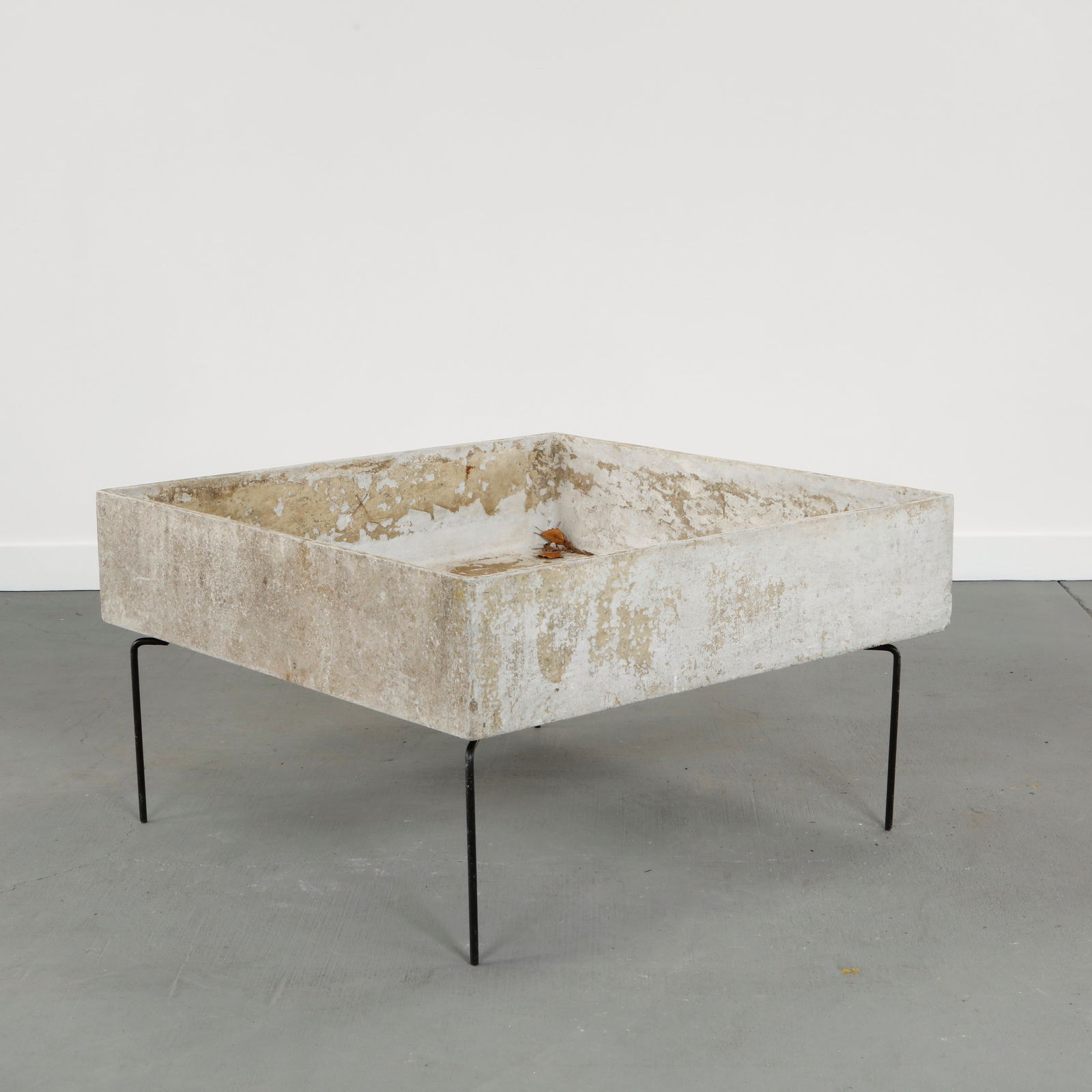Willy Guhl, Monumental Square Concrete Planter on Stand, 1960s: Large square molded concrete planter elevated on a minimalist steel stand. Characterized by sharp geometry and expressive weathered patina. An iconic outdoor form illustrating Willy Guhl sculptural