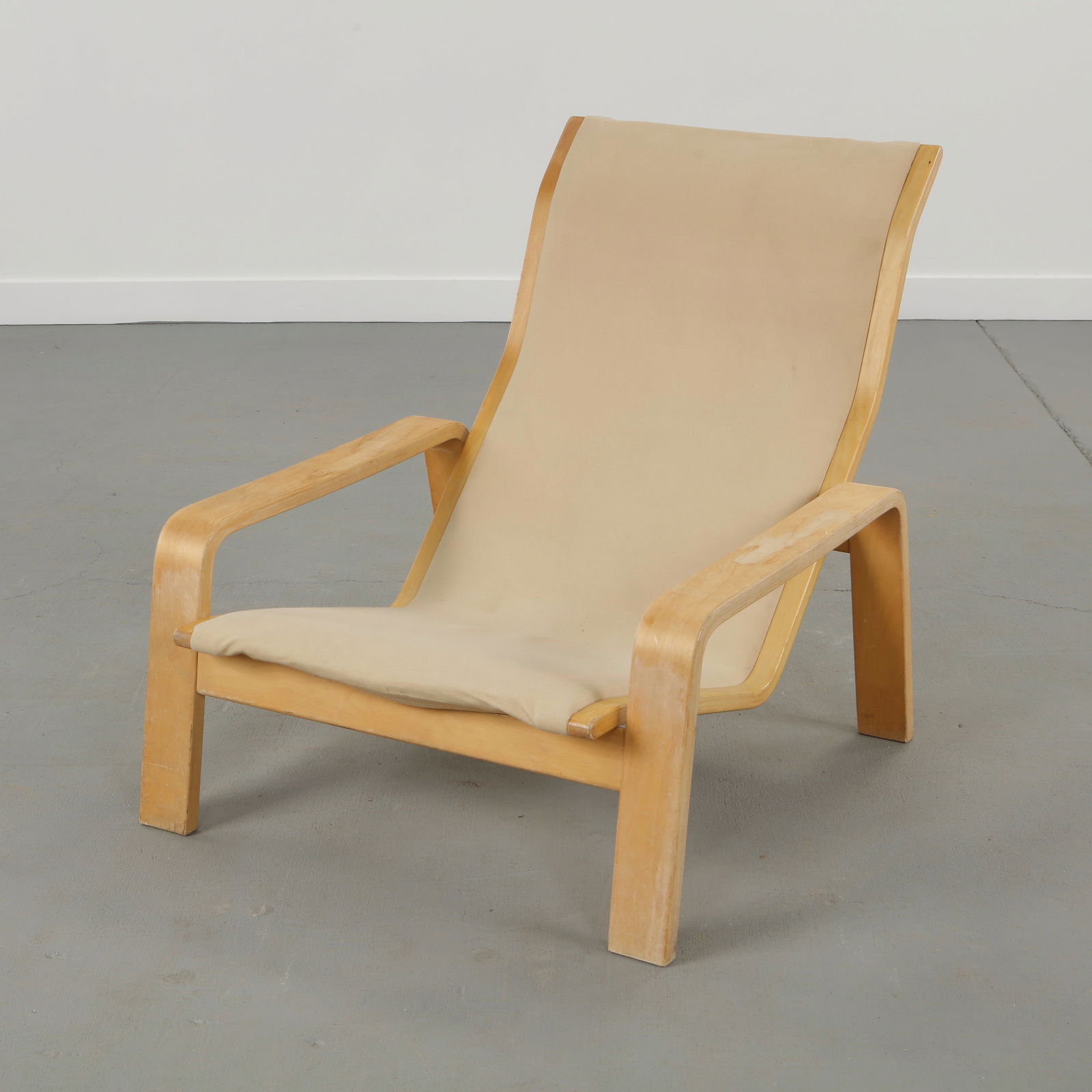 Ilmari Lappalainen for Asko, Fabric Pulkka Lounge Chair, Finland, 1960s: Executed in molded birch with fabric upholstery, this Pulkka lounge chair is defined by fluid lines and a generous, ergonomic seat. The textile surface softens the architectural form, offering a