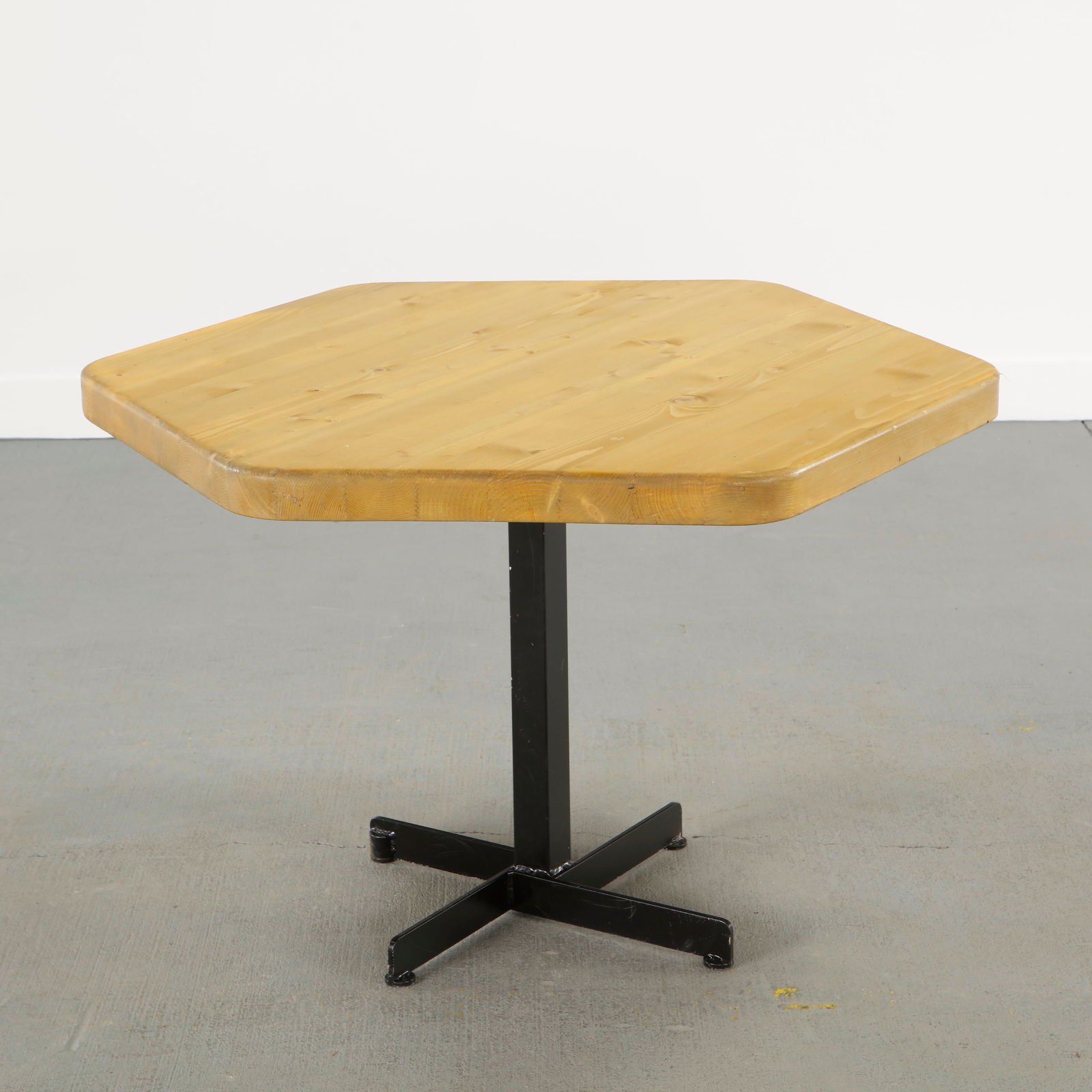 Charlotte Perriand for Les Arcs 1600, Hexagonal Dining Table, 1960s: Crafted with a solid pine hexagonal top resting on a black lacquered steel base. An emblematic dining table conceived for Les Arcs, expressing Charlotte Perriand commitment to modular alpine living