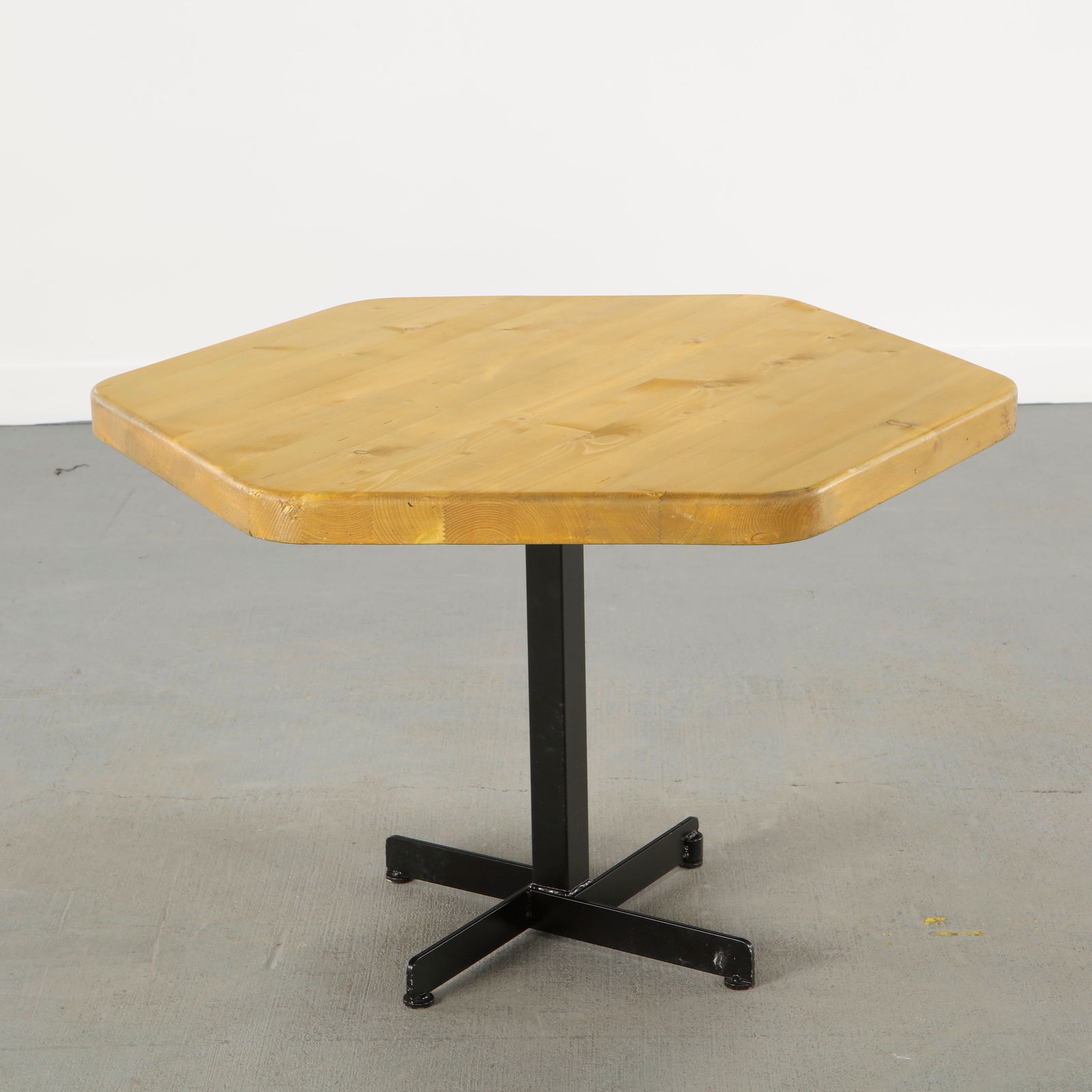 Charlotte Perriand for Les Arcs 1600, Hexagonal Dining Table, 1960s: Crafted with a solid pine hexagonal top resting on a black lacquered steel base. An emblematic dining table conceived for Les Arcs, expressing Charlotte Perriand commitment to modular alpine living
