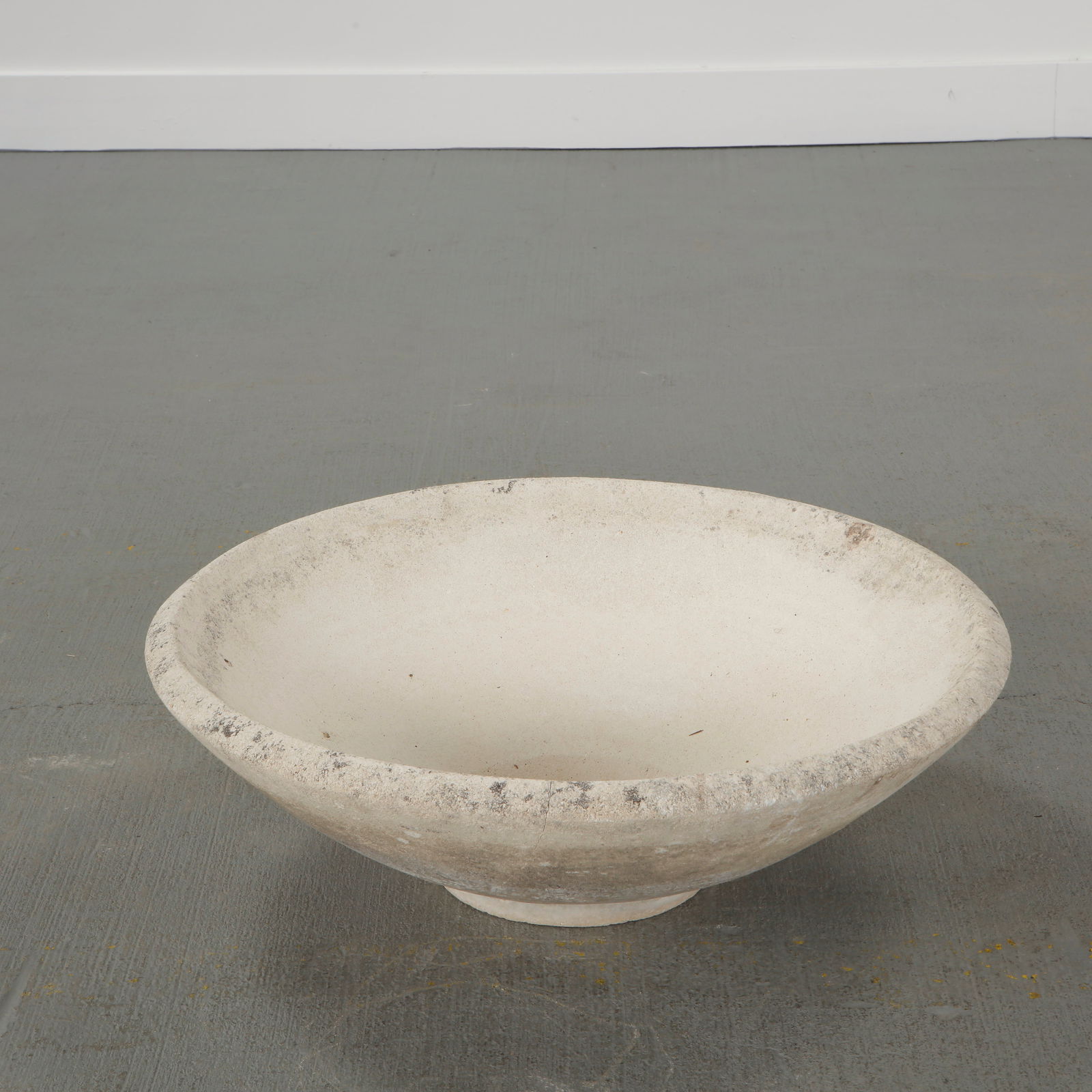 Small Conical Cast Stone Planter, 1960s: Cast stone planter with a restrained conical profile and softly weathered surface.A minimalist garden element reflecting mid-century functional design. Height: 8 in. Diameter: 25.5 in.