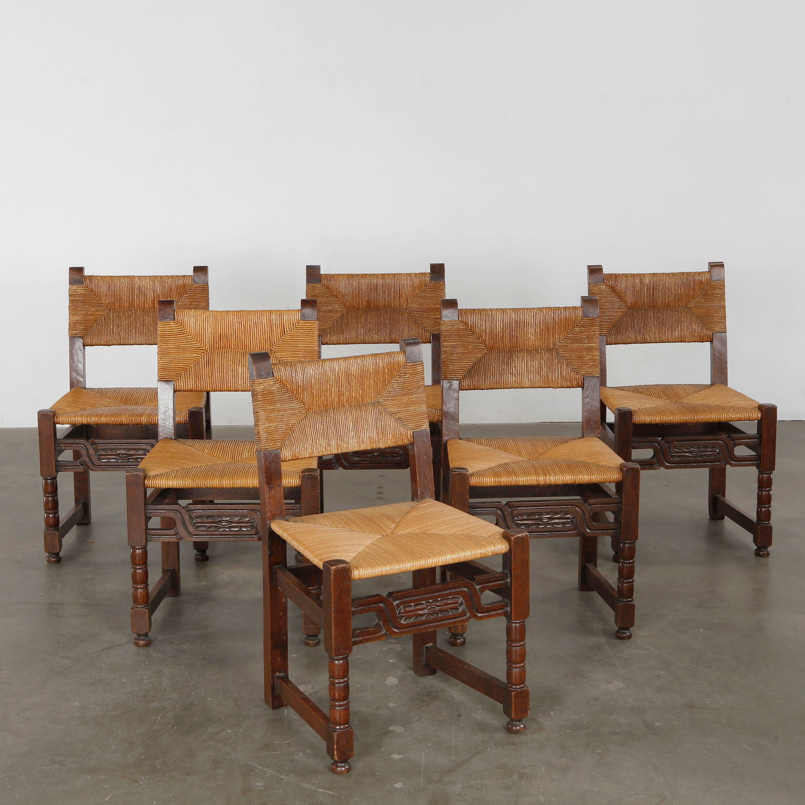 Set of Six Brutalist Wood and Rope Chairs, 1960s: Sturdy silhouettes with rope seating, fusing rural tradition and modernist edge. Height: 33.5 in. Width: 19.5 in. Depth: 17 in. Seat Height: 18.2 in.
