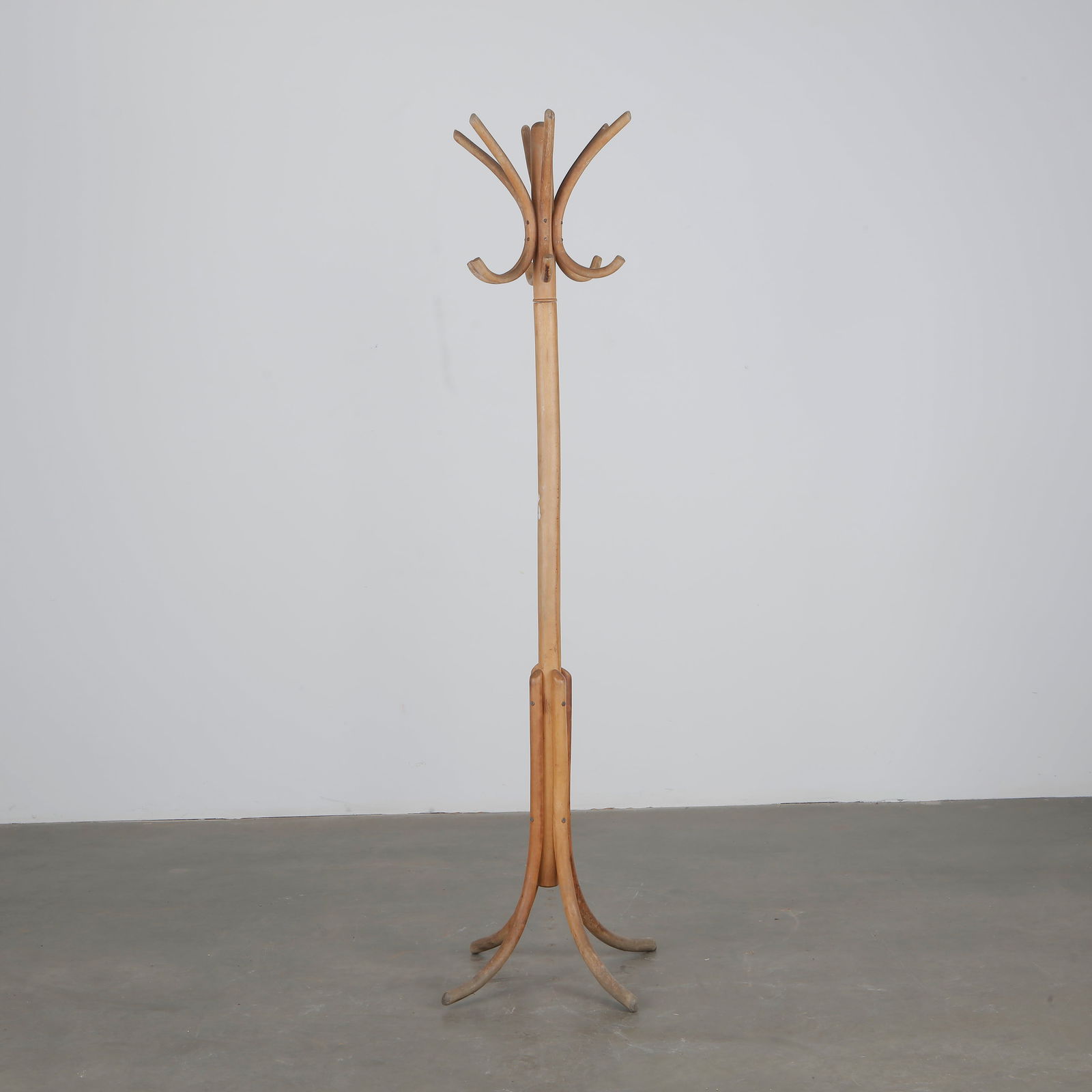 Baumann, Bistro Coat Rack, 1950s: Classic bentwood coat rack by Baumann with elegant curved hooks and tripod base, typical of mid-century French bistro style. France, 1950s.Height: 72 in. Width: 12 in. Feet Width: 13 in.
