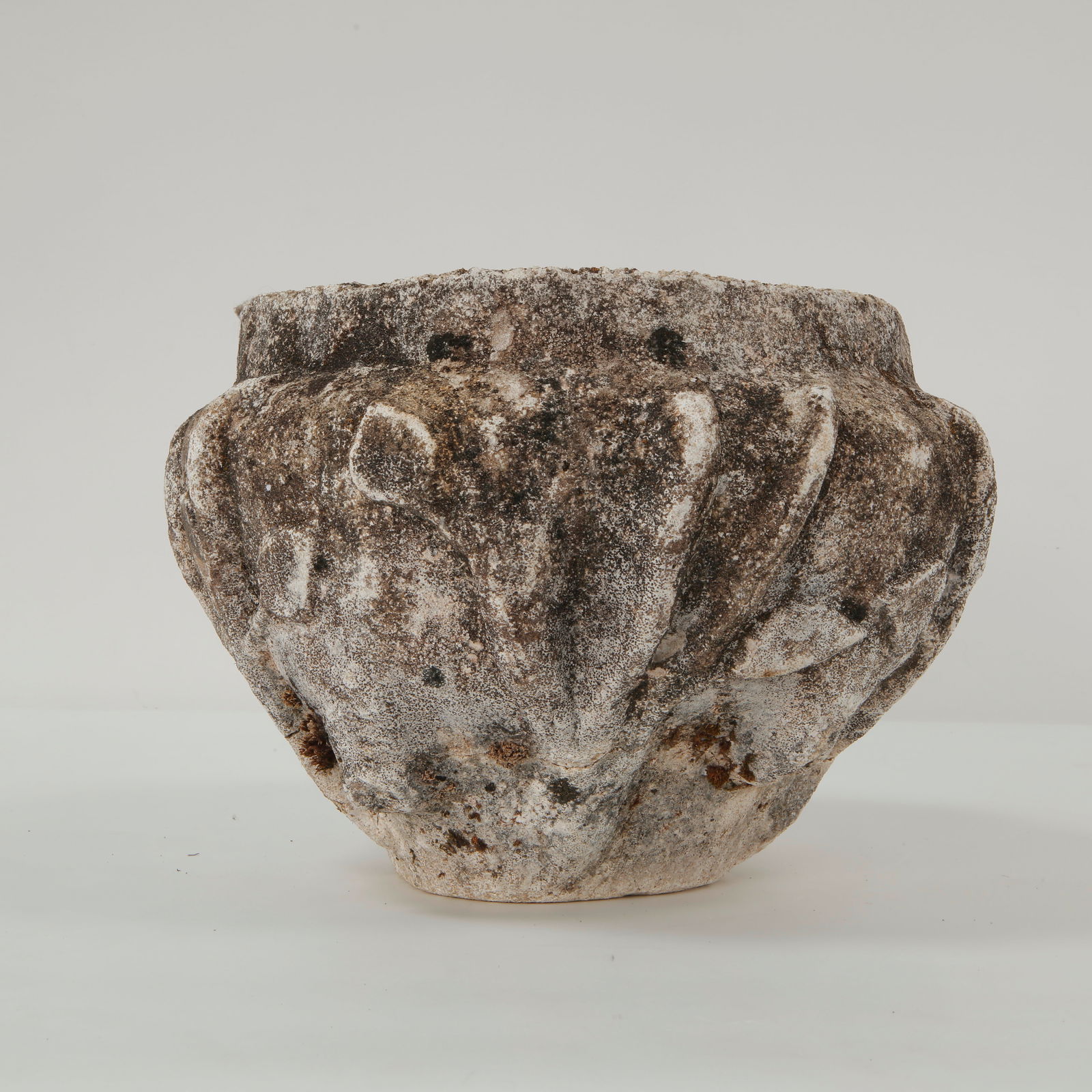 Round Carved Stone Planter, 1940s: Carved stone planter featuring a deeply lobed body with pronounced relief modeling. The compact proportions and hand-worked surface reflect traditional garden ornamentation, enhanced by a naturally