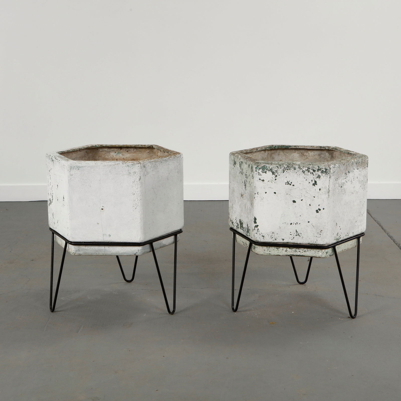 Willy Guhl, Pair of Octagonal Concrete Planters on Stands, 1960s: Pair of octagonal molded concrete planters raised on metal stands. Displaying expressive aging with traces of lichen and mineral deposits. Highly sought-after examples of Swiss modernist outdoor desig