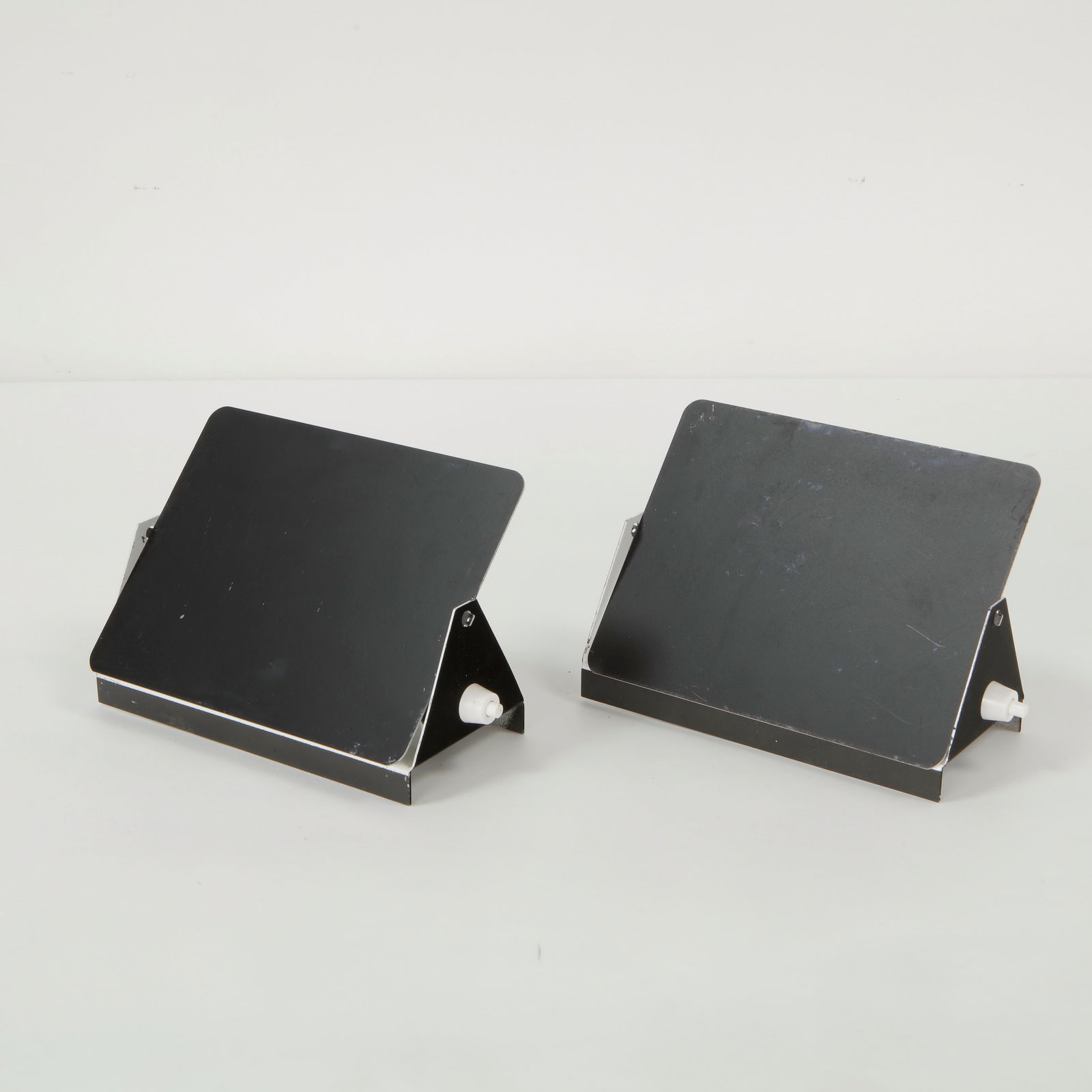 Charlotte Perriand, Pair of CP1 Wall Sconces, 1963: Pair of Charlotte Perriand CP1 Wall Sconces. Black and white pivoting aluminum wall lights, an iconic modernist design by Perriand. Height: 5.9 in. Length: 6.45 in. Width: 2.5 in.