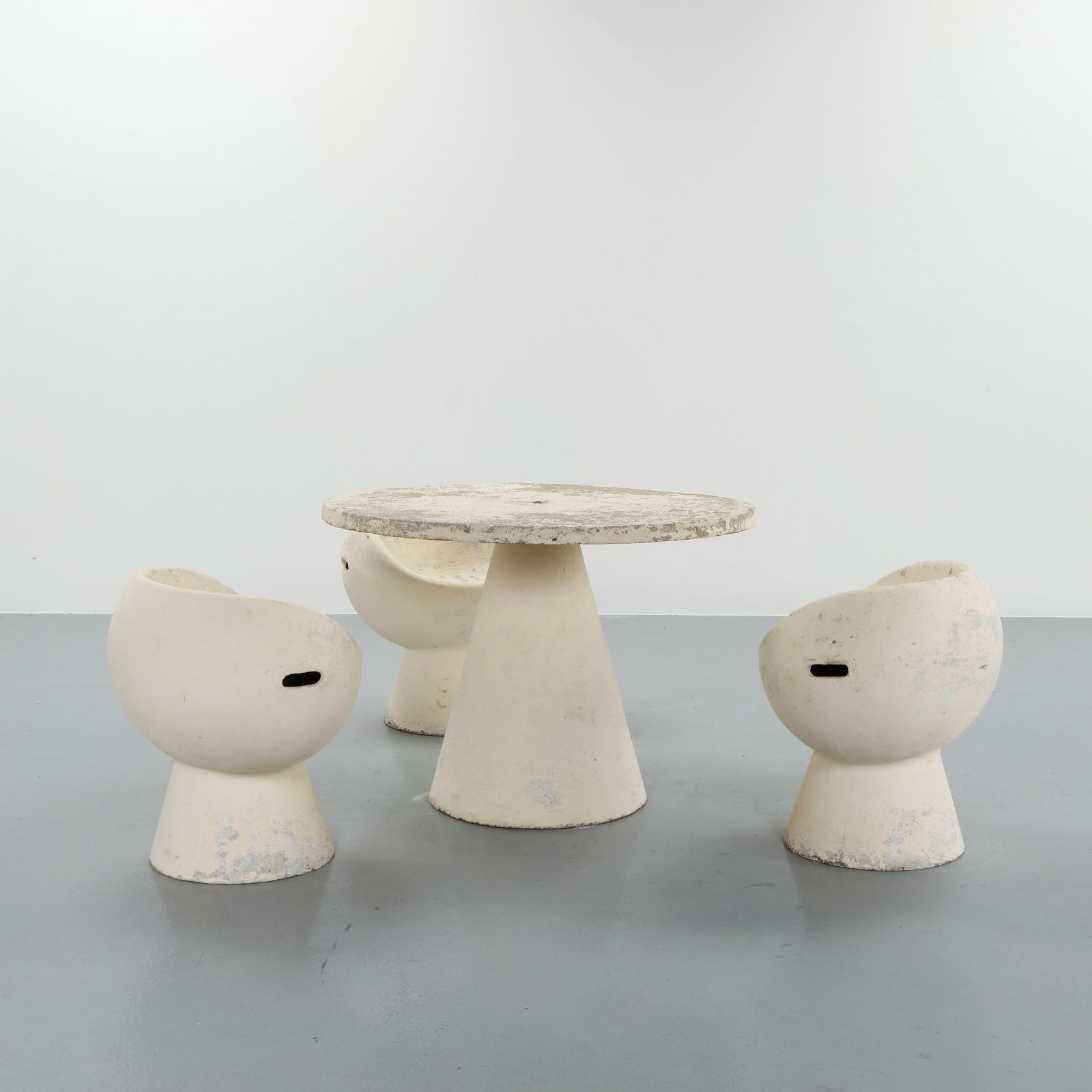 Willy Guhl, Pod Outdoor Dining Set, 1960s: Rare outdoor dining set executed in molded fiber cement, featuring a circular table and matching pod-shaped seats. The organic silhouettes and material innovation exemplify Guhl sculptural approach to