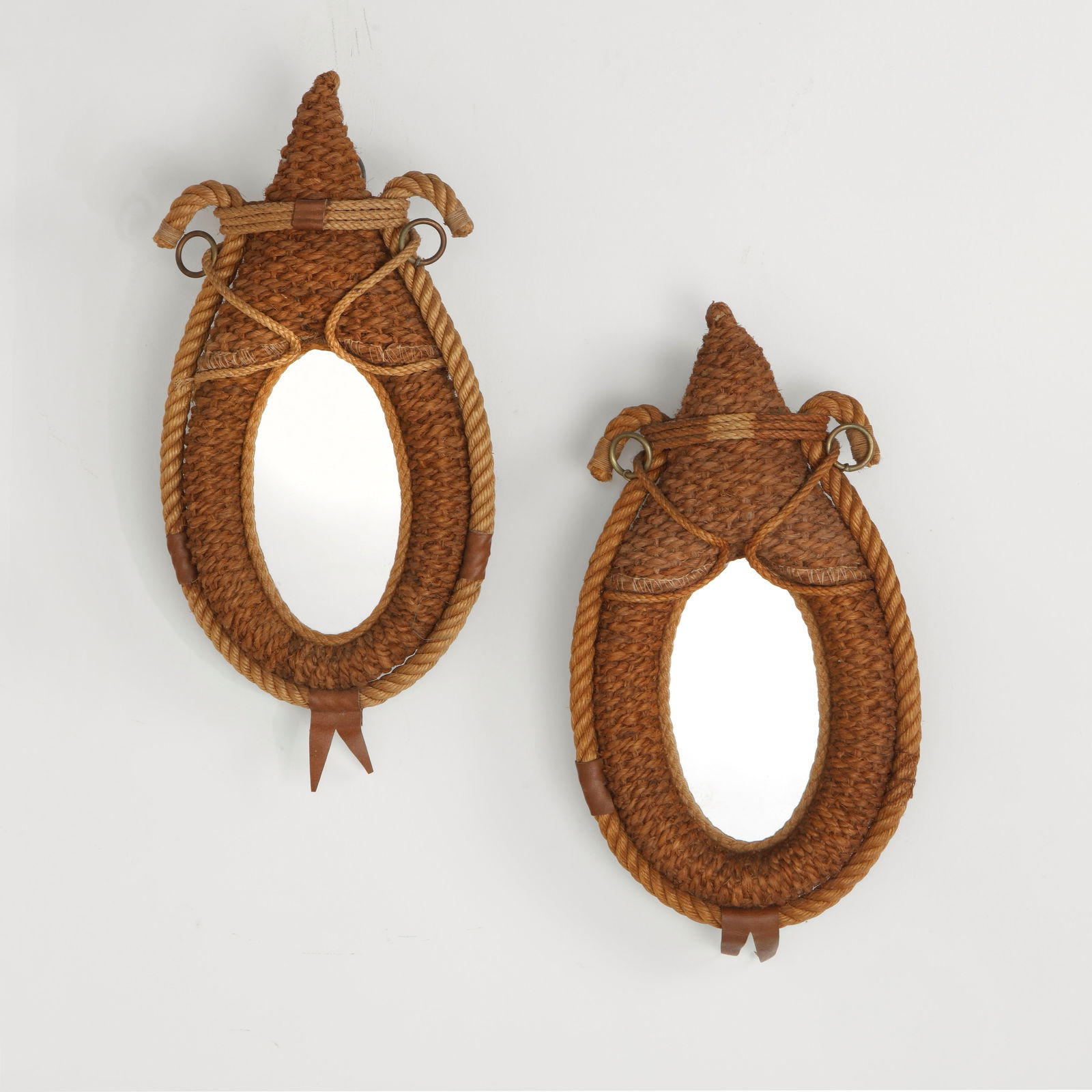 Audoux Minet, Pair of Small Rope Mirrors, 1950s: Charming pair of wall mirrors encased in stylized sculptural rope frames with equestrian-inspired leather details. Crafted circa 1960 by French design duo Audoux & Minet. Height: 18 in. Width: 10 in.