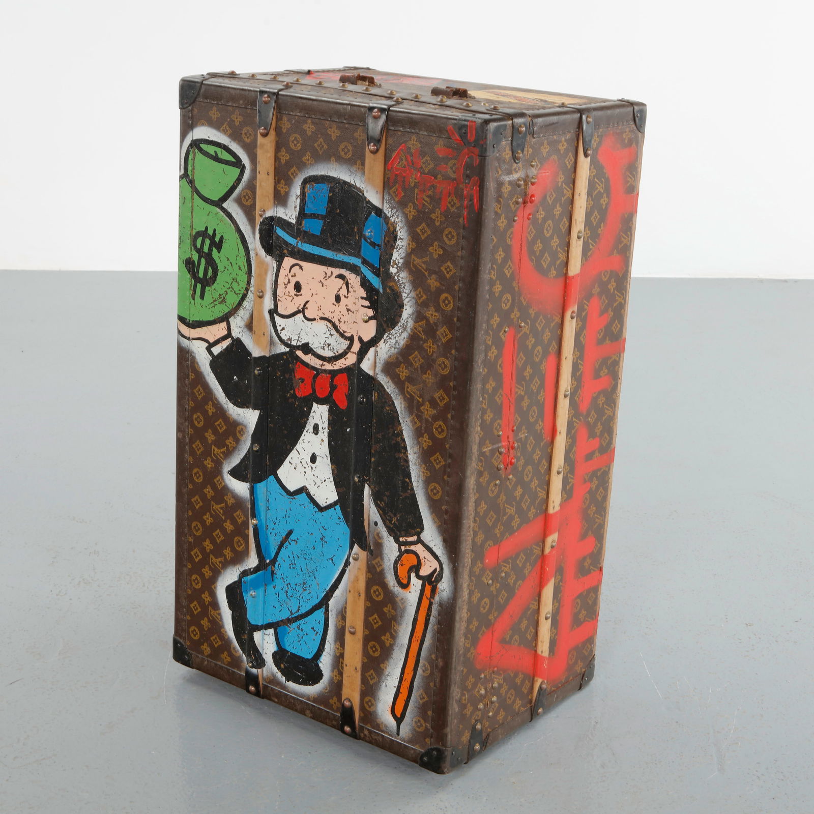 Alec Monopoly, Customized Louis Vuitton Steamer Trunk, Monogram Canvas, 2010s: Vintage Louis Vuitton steamer trunk in monogram canvas and reinforced wood frame, reimagined by Alec Monopoly with hand-painted graffiti interventions featuring the iconic Monopoly figure and bold cur