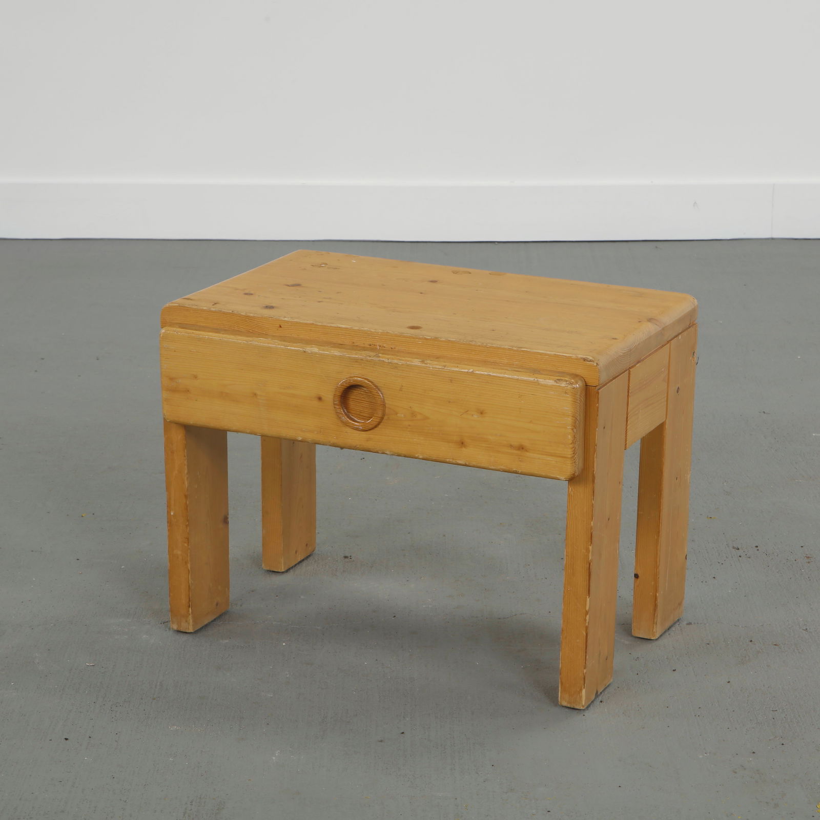 Charlotte Perriand for Les Arcs 1600, Pine Nightstand, 1960s: Solid pine nightstand table designed by Charlotte Perriand for Les Arcs resort, featuring minimalist lines and integrated drawer pull. France, 1960s. Height: 15 in. Length: 20 in. Width: 13.5 in.