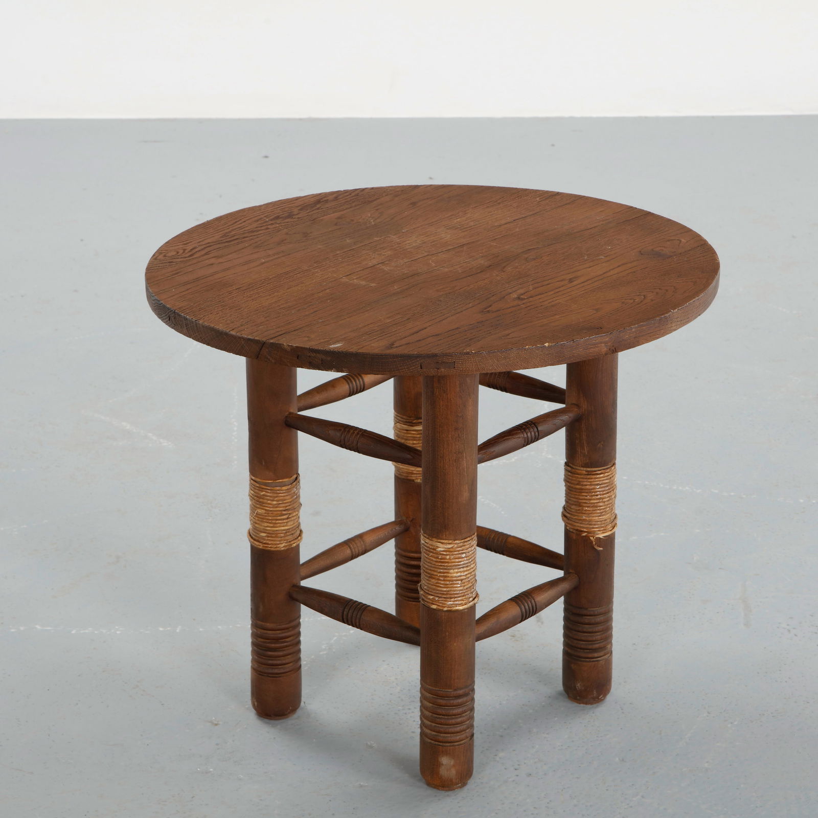 Audoux-Minet, Round Wood Side Table, 1960s: Circular top resting on a sturdy wooden base, emphasizing balance and simplicity. The warm patina and restrained form make it a versatile example of mid-century French furniture. Height: 20.5 in. Diam