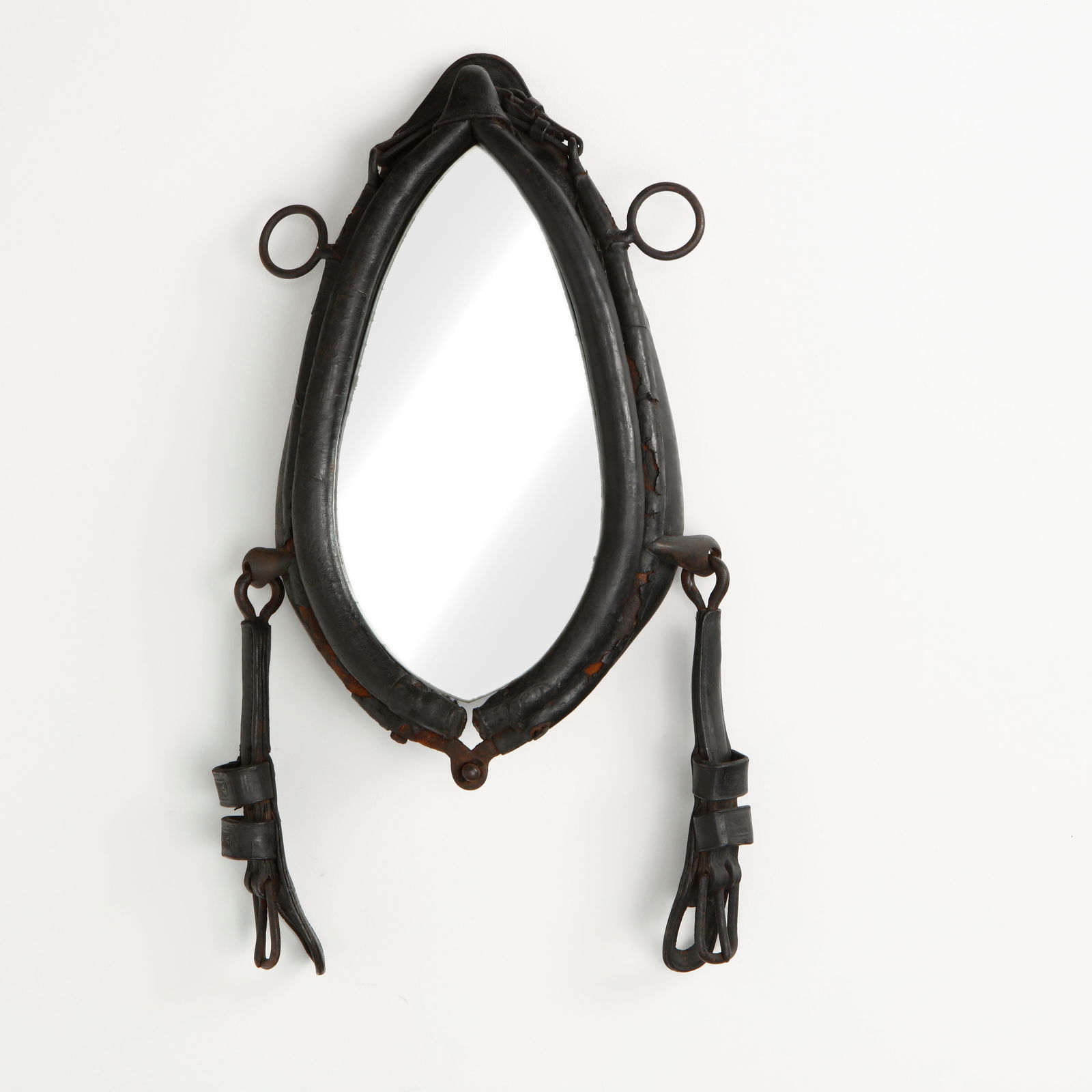 19th Century French Leather Mirror in the style of Jacque Adnet: Framed in thick, hand-stitched leather with iron hardware, this mirror reflects the utilitarian elegance of 19th century French craftsmanship. The aged patina and robust construction confer a