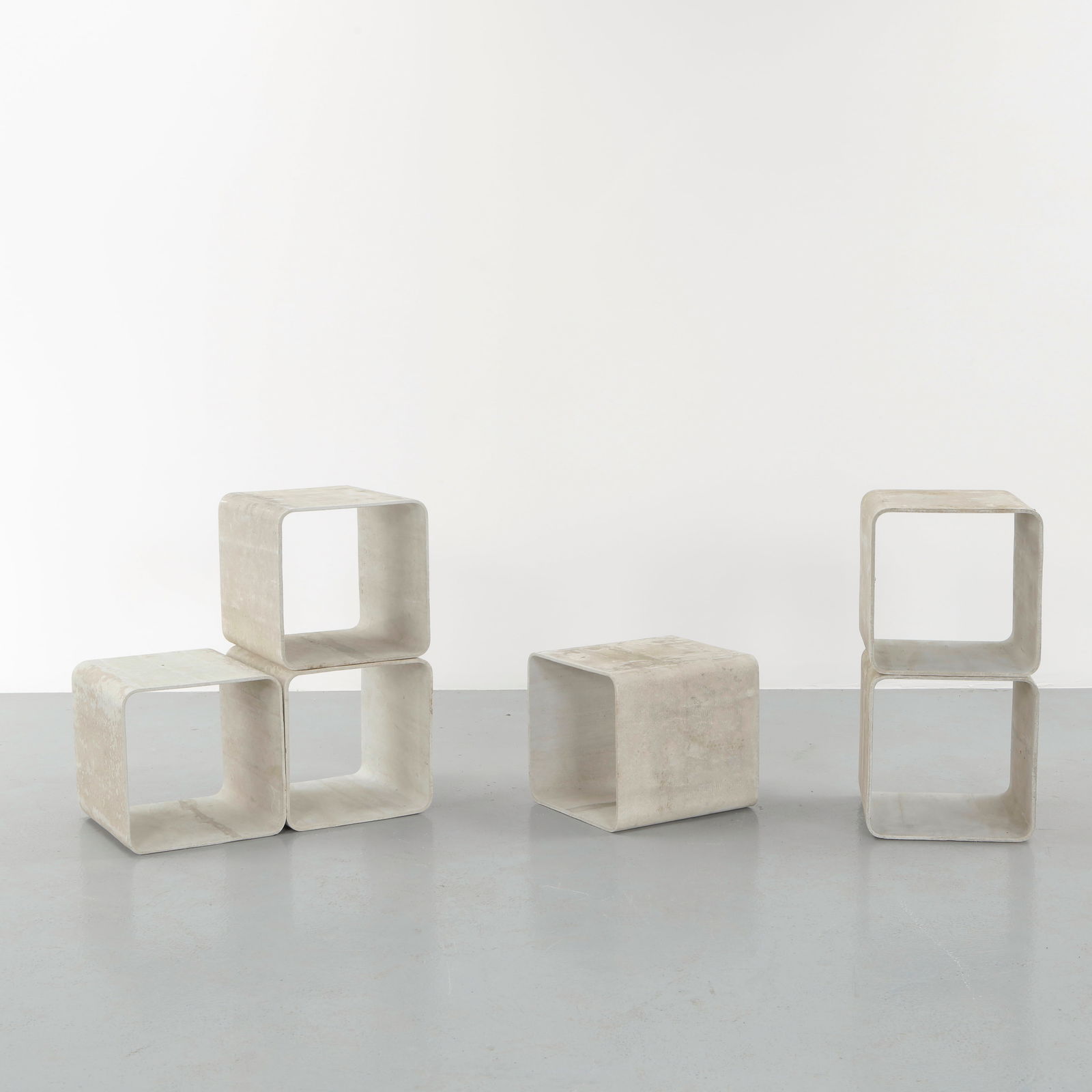 Willy Guhl, Set of Six Modular Cement Cube Library, 1960s: Cast in fiber cement with a distinctive curved profile, these modular units demonstrate Guhl innovative use of industrial materials. Their sculptural form allows versatile stacking or alignment. A