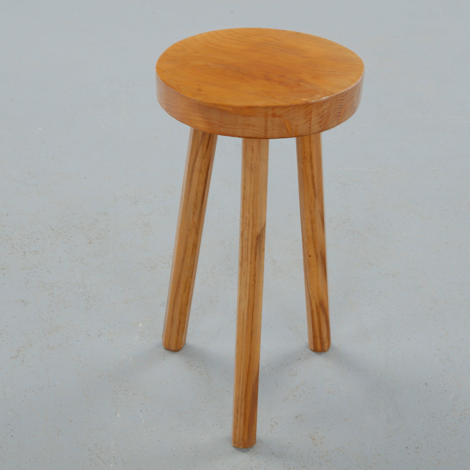 Brutalist Wood Stool, 1960s: Carved from solid wood, this stool features a thick circular seat raised on three tapered legs, emphasizing mass, materiality, and structural honesty. The visible grain and subtle irregularities highl