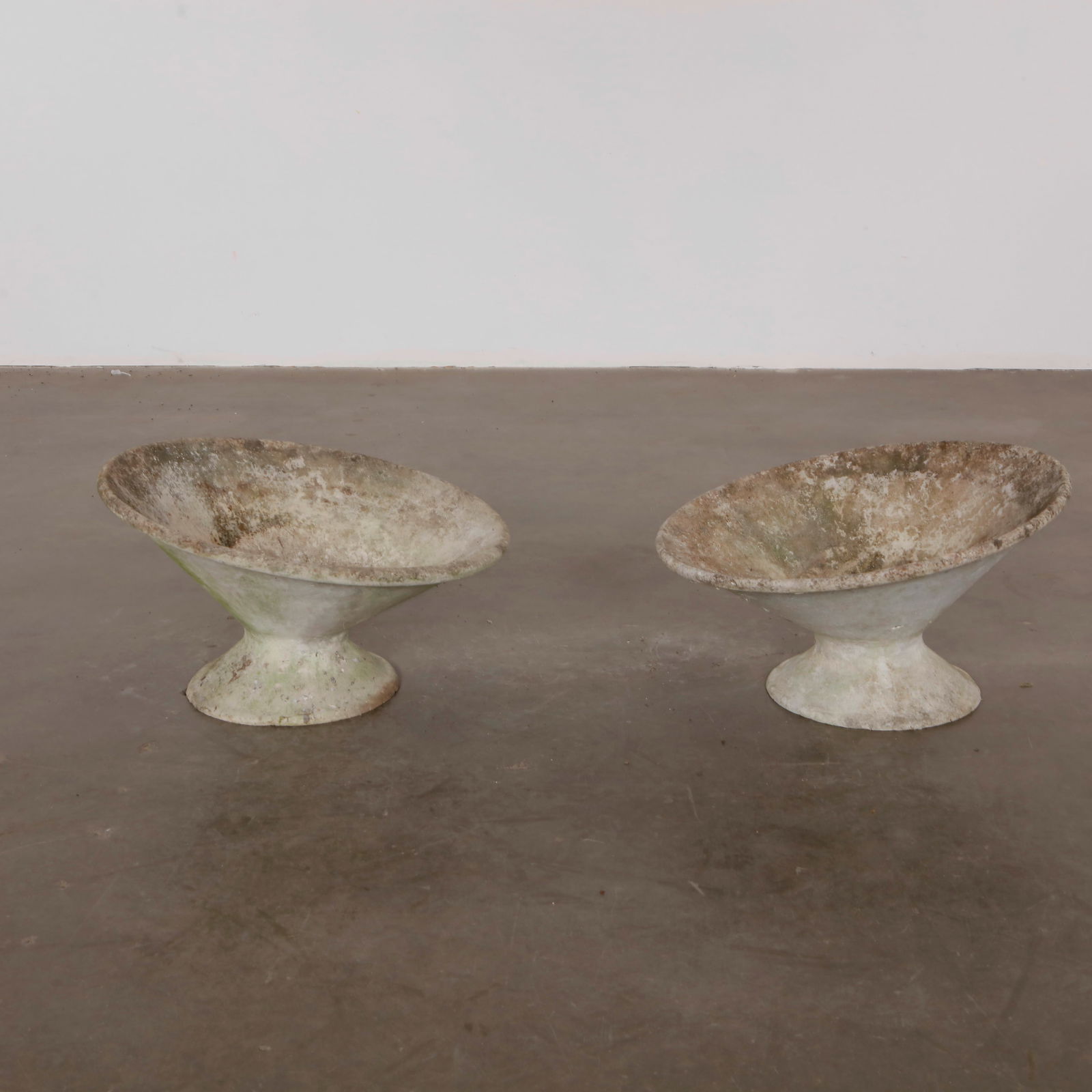 Willy Guhl, Pair of Off Kilter Planters, 1960s: A pair of rare asymmetrical planters by Willy Guhl, featuring a bold modernist design. TOP Diameter: 25 in. BASE Diameter: 13 in. Height: 14.5 in.