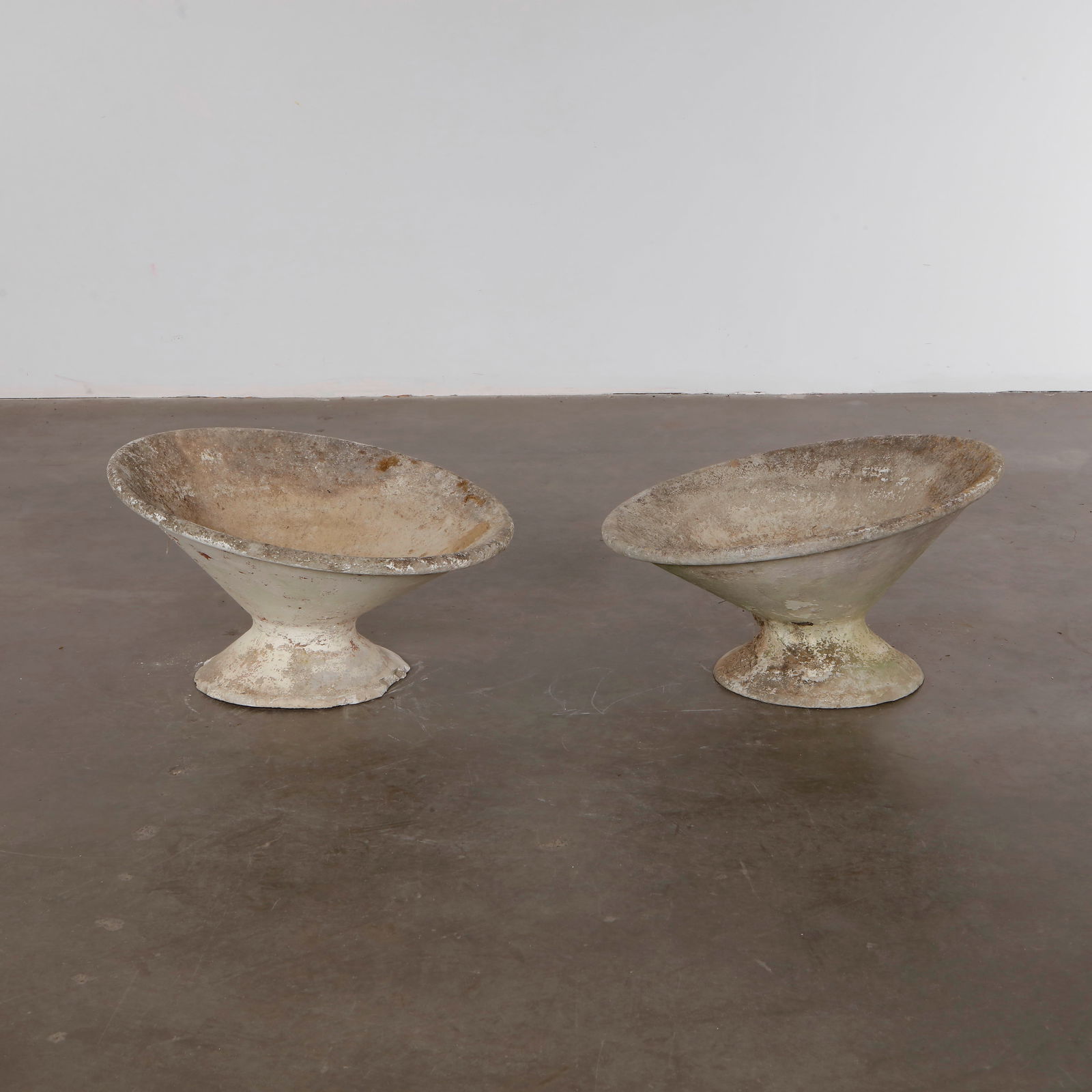 Willy Guhl, Pair of Off Kilter Planters, 1960s: A pair of rare asymmetrical planters by Willy Guhl, featuring a bold modernist design. TOP Diameter: 25 in. BASE Diameter: 13 in. Height: 14.5 in.